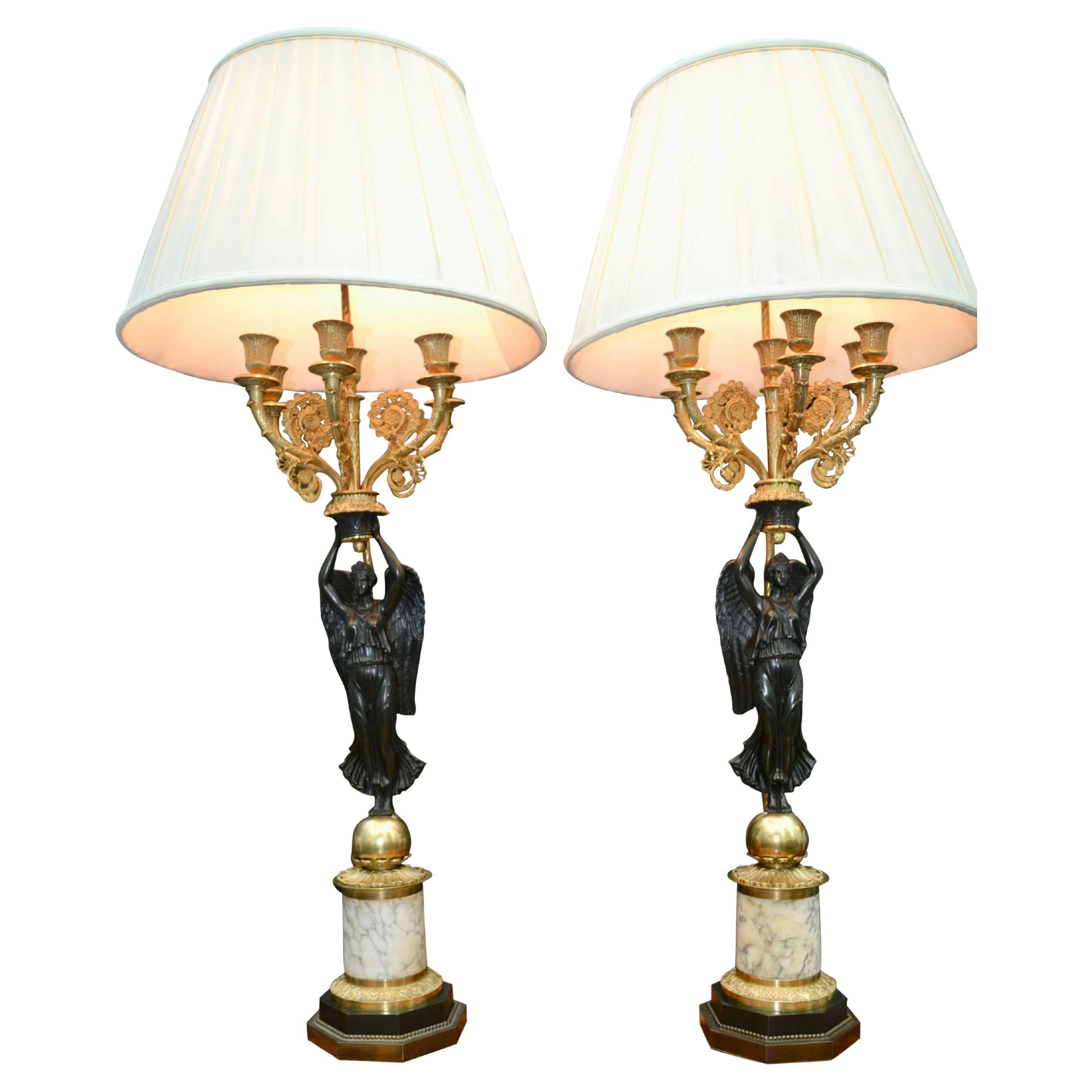 A Pair of French Empire Style Patinated and Gilt Bronze Winged Victory Lamps For Sale