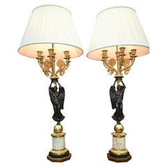 A Pair of French Empire Style Patinated and Gilt Bronze Winged Victory Lamps