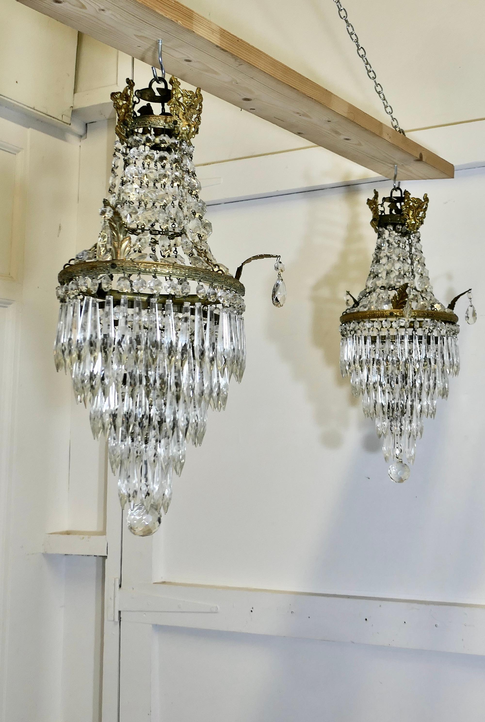 A Pair of French Empire Style Tent and Waterfall Chandeliers

These are lovely pieces, they have a brass frame hung with chains of cut crystal  beads, completed at the bottom with 5 Waterfall tiers of crystal drops and a faceted cut globe at the
