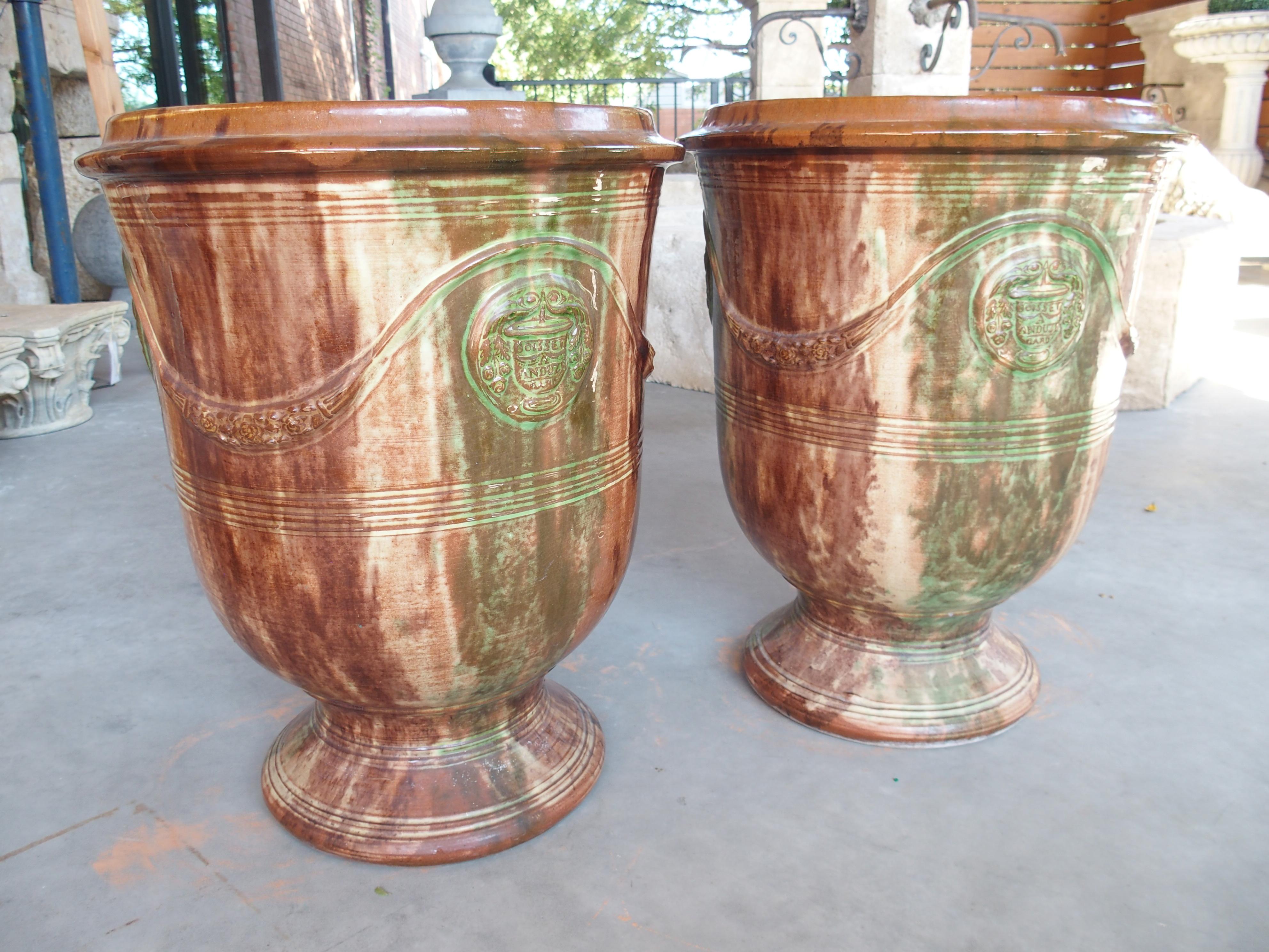 More information coming soon…

A unique take on the classic Anduze pots, this stunning multicolored pair is by the French foundry, Boisset, which has been producing pottery since 1610.  The Boisset Anduze pot, with the floral swag and coat of arms,