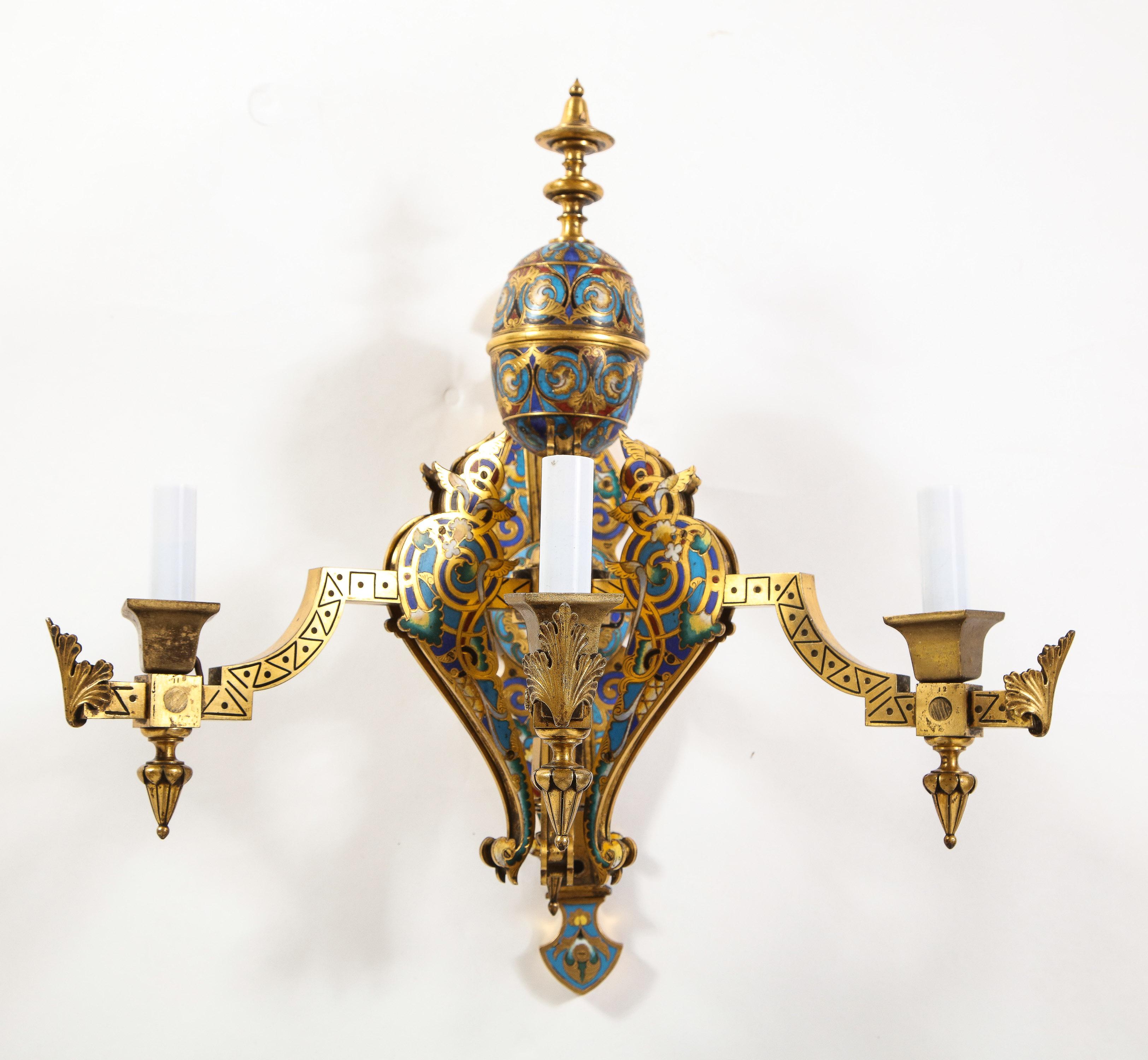 A Marvelous Pair of Gilt Bronze and Multi-Colored Champleve Enamel Three-Arm Wall Appliques/Sconces, Attributed to Barbedienne. This fantastic pair of sconces are each cast, hand-chased, and hand-chiseled with fantastic quality and craftsmanship.