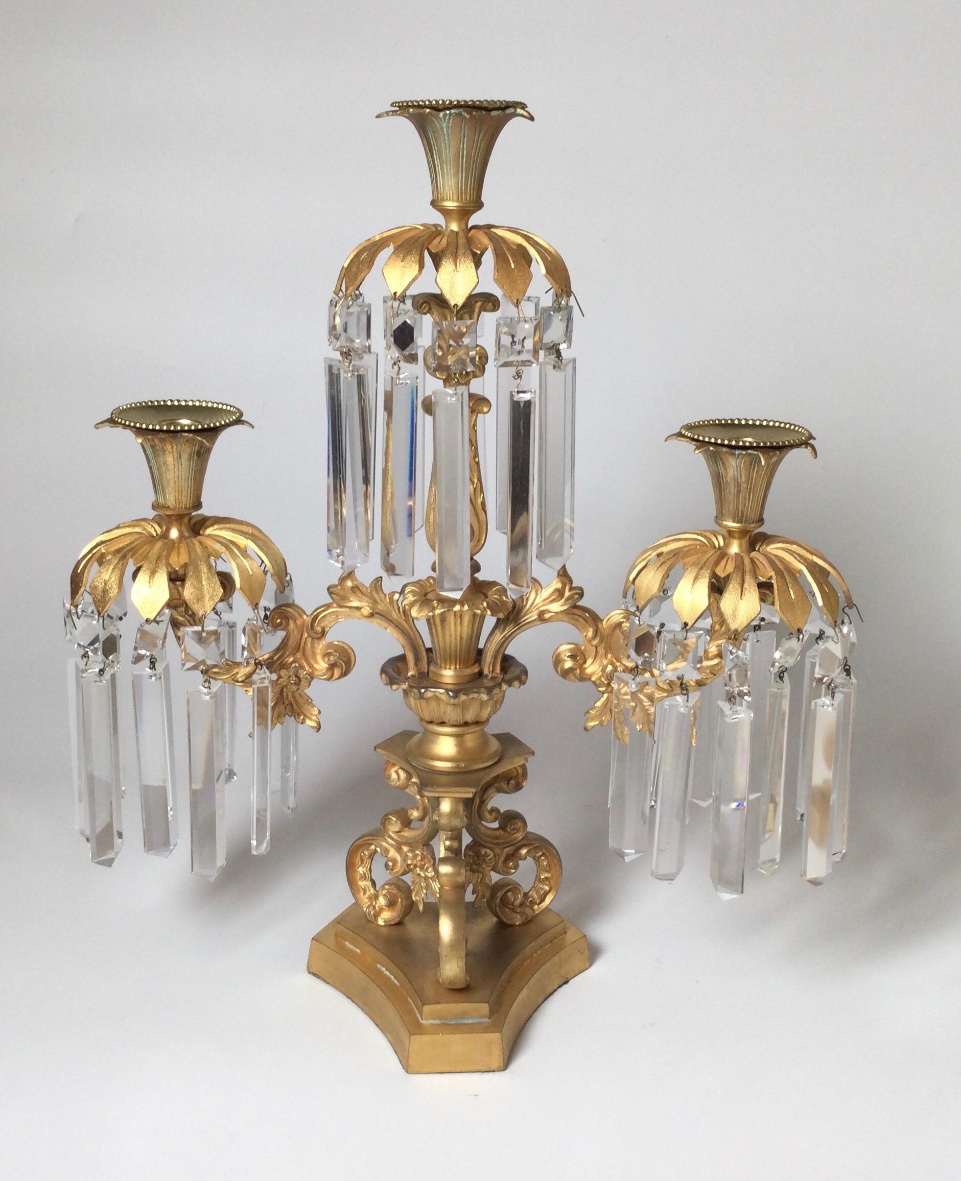 Elegant pair of cast and gilt bronze candelabra lusters. The three arms with long panel cut crystals with scrolling center column, France Circa 1880's.