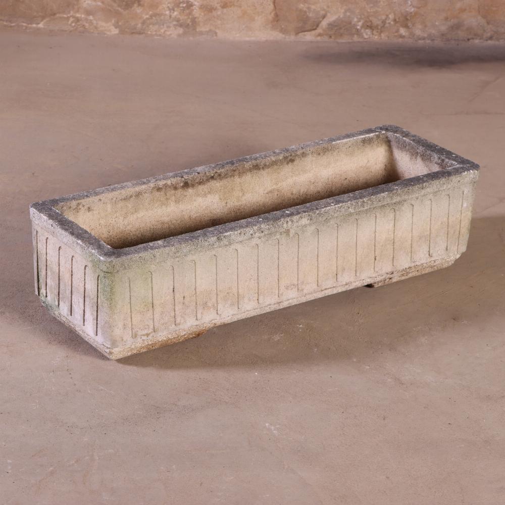 A distinctive pair of French cast stone planters, circa 1950, bearing the mark Grandon Frès. These planters feature subtle Art Deco styling, with clean lines and restrained geometric detailing. The cast stone surfaces have acquired a beautifully