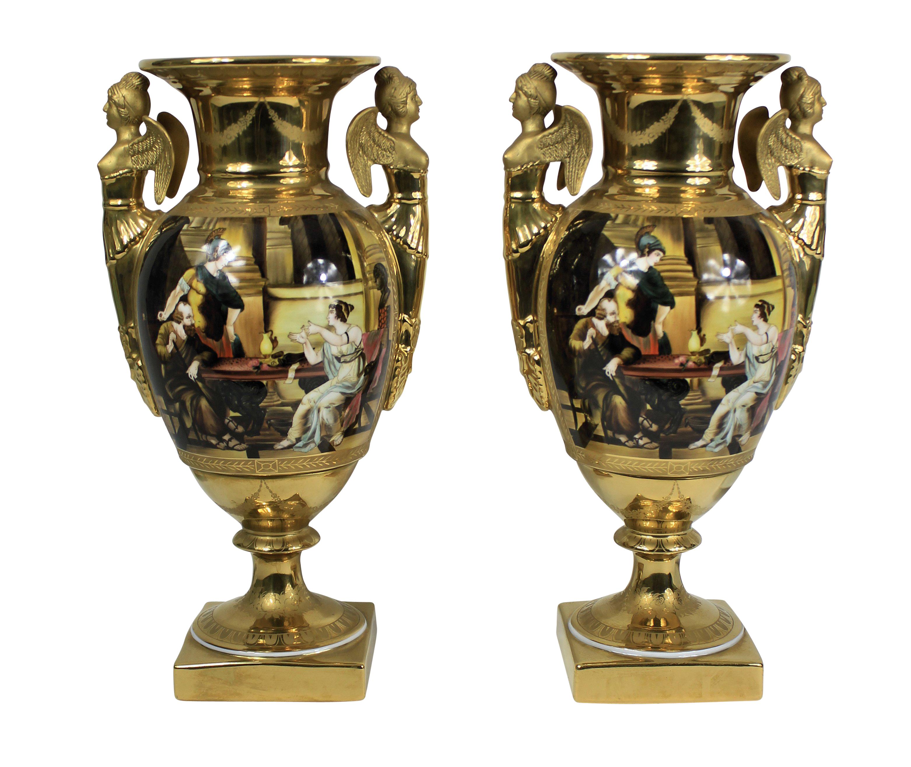A pair of French hand painted ground gold porcelain vases, depicting Classical scenes, with an armorial crest and crown.