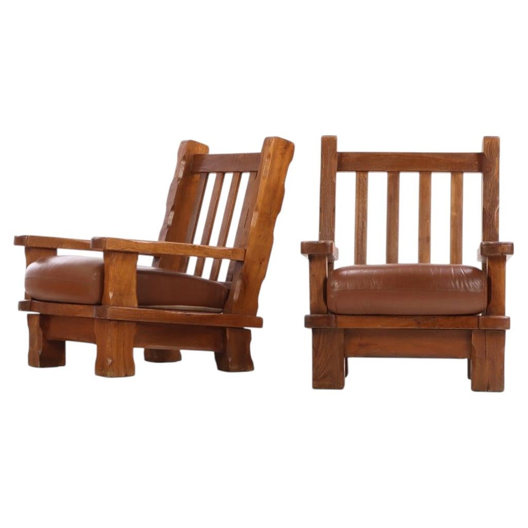 A Pair of French Heavy Oak Brutalist style Open Arm Chairs, C. 1960.