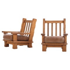 A Pair of French Heavy Oak Brutalist style Open Arm Chairs, C. 1960.