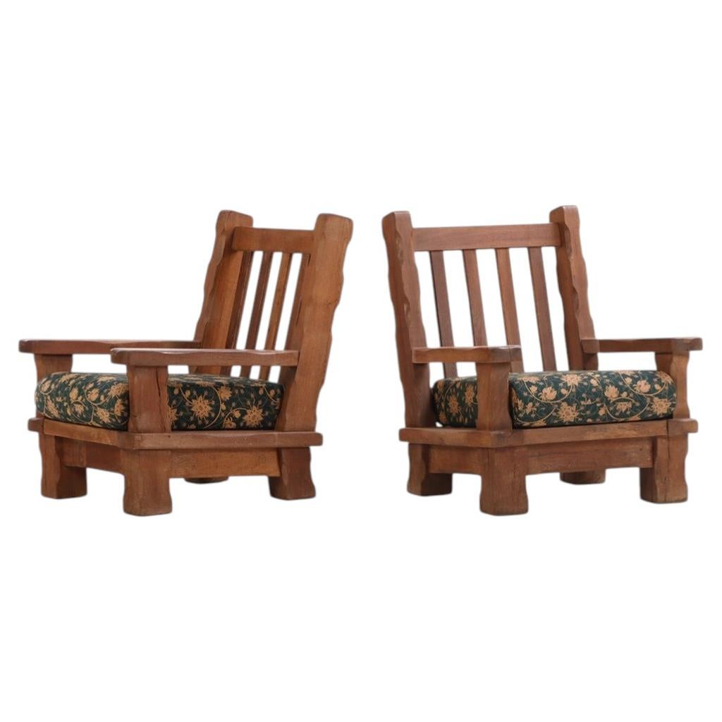 A Pair of French Heavy Oak Brutalist style Open Arm Chairs, C. 1960.