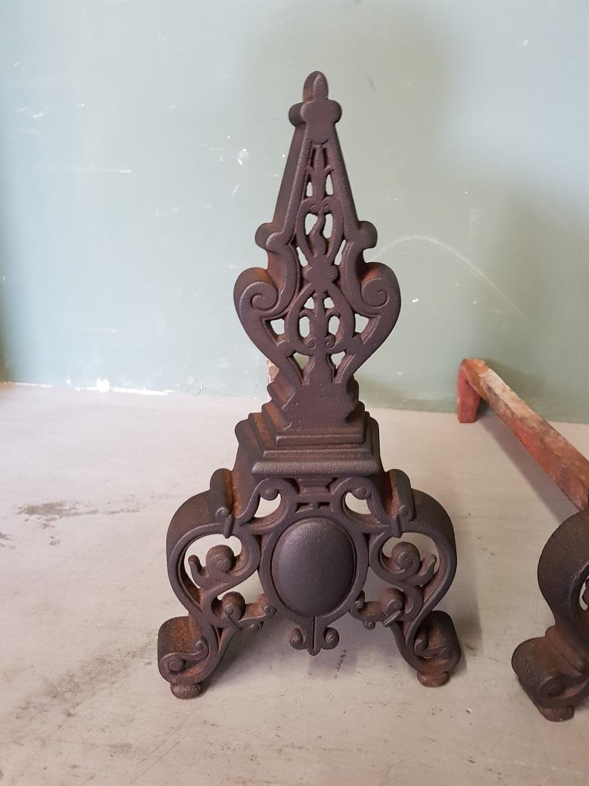 Antique French metal andirons/chenets in a neoclassical version with openwork design, both are in a good but used condition. Originating from the end of the 19th century.

The measurements are:
Depth 41 cm/ 16.1 inch.
Width 18 cm/ 7