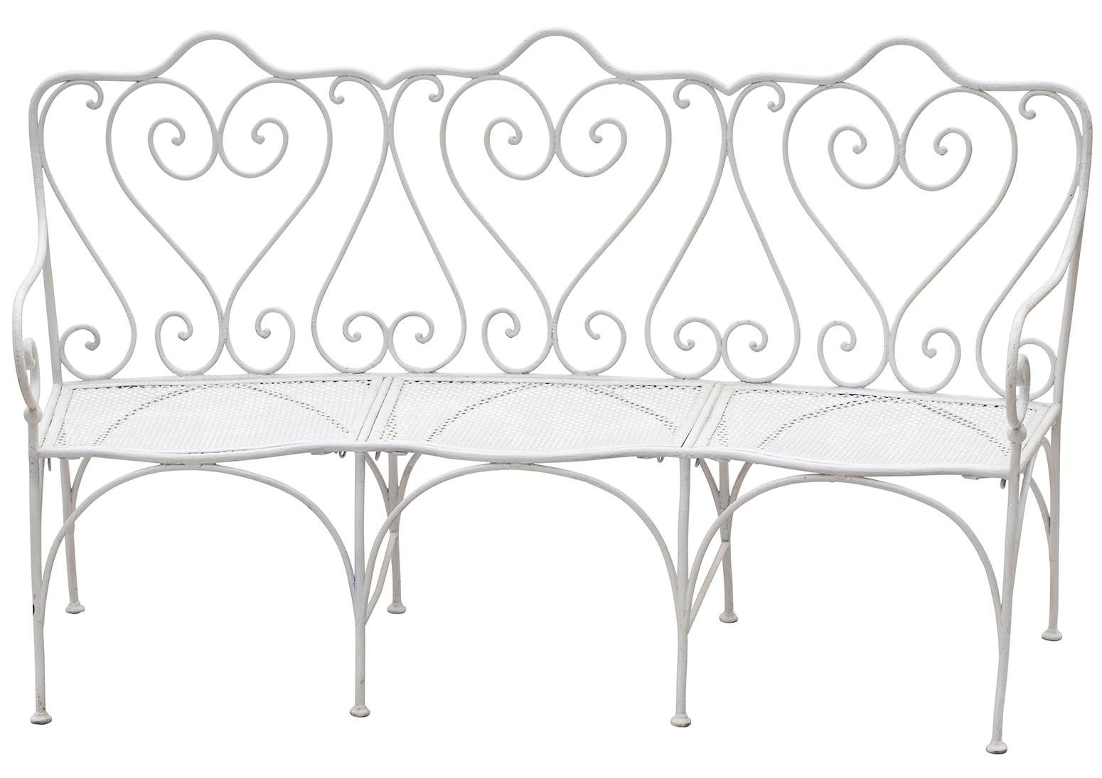 A good quality pair of French wrought iron garden benches circa 1890, with great details typical of the period. The back is divided into three parts with a scrolled motif designating each. The pierced metal seat has a curved front and is divided