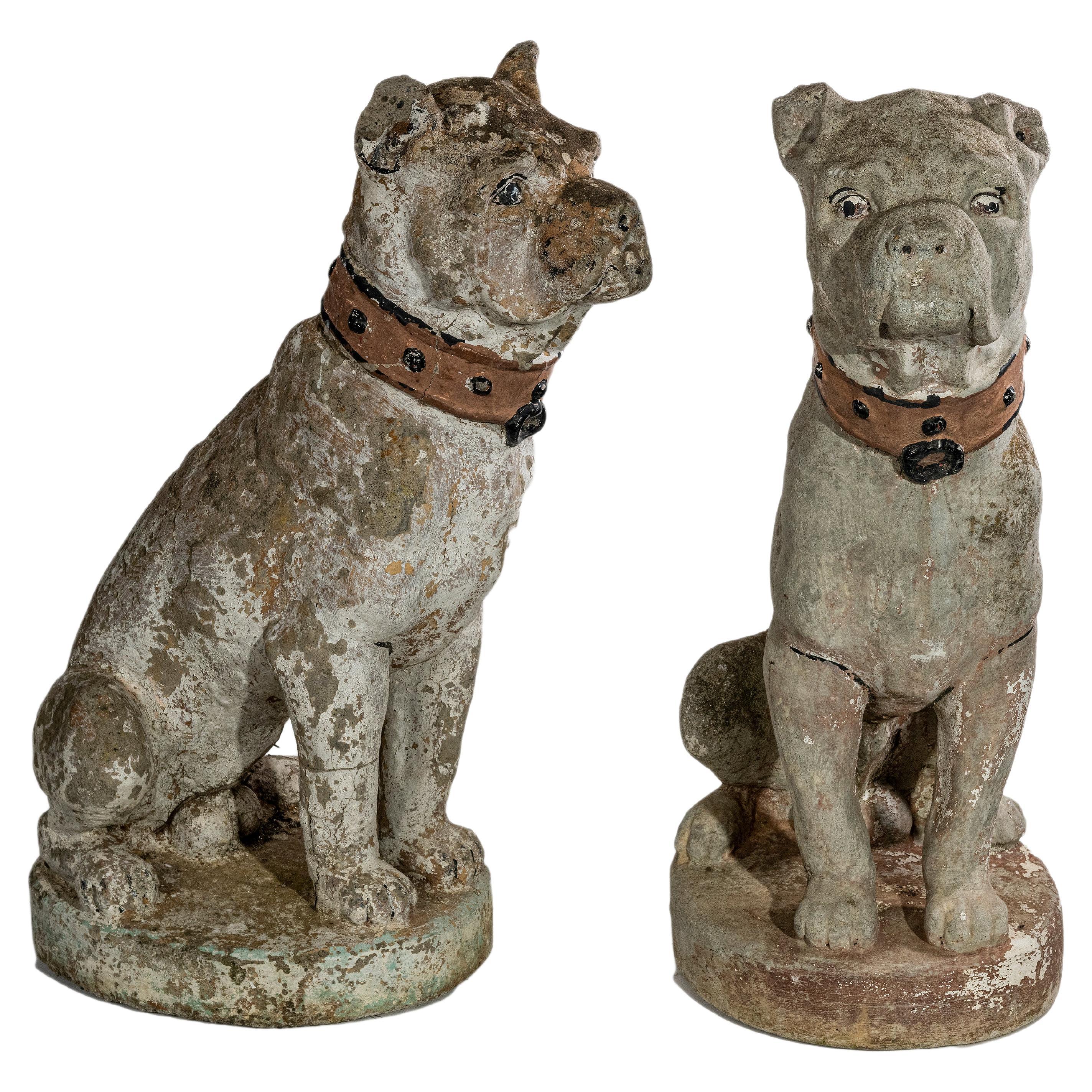 A pair of French late 19th early 20th century cement dogs