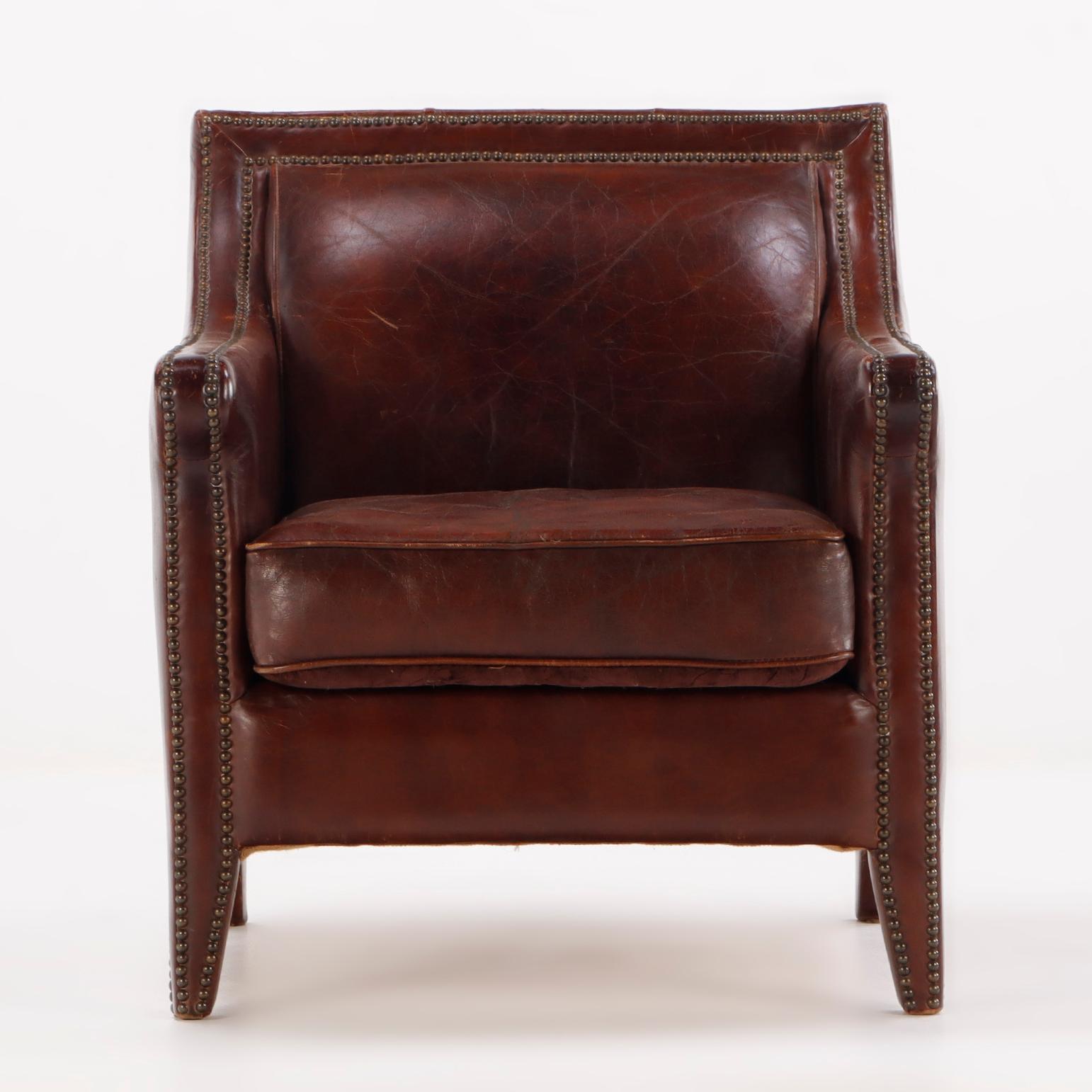 Hard to find pair of French leather club chairs C 1970 having brass tack details. These chairs are not only a great design but also large in scale.