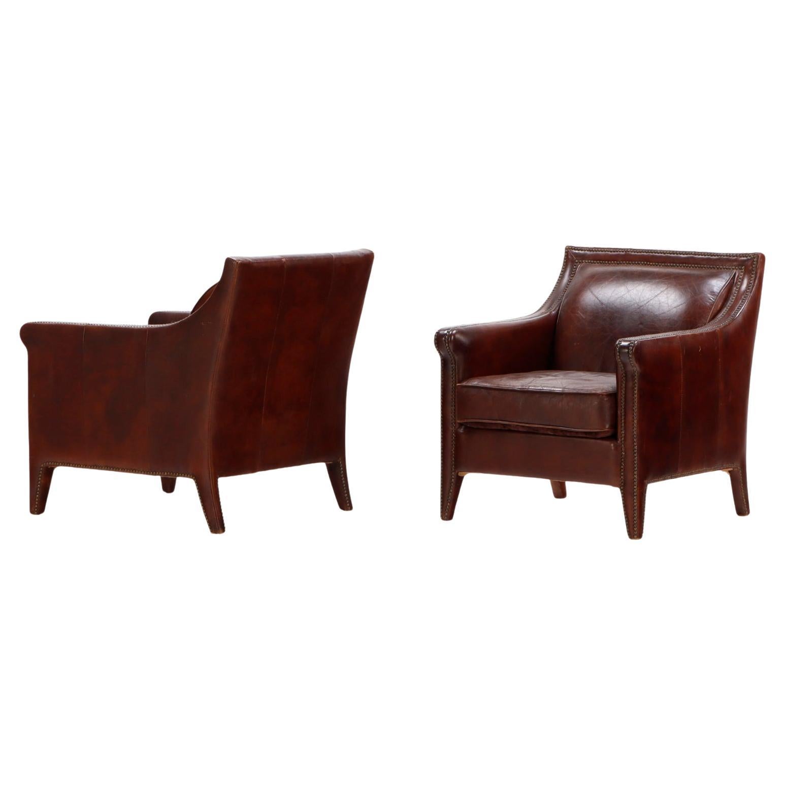 A pair of French leather club chairs circa 1970.