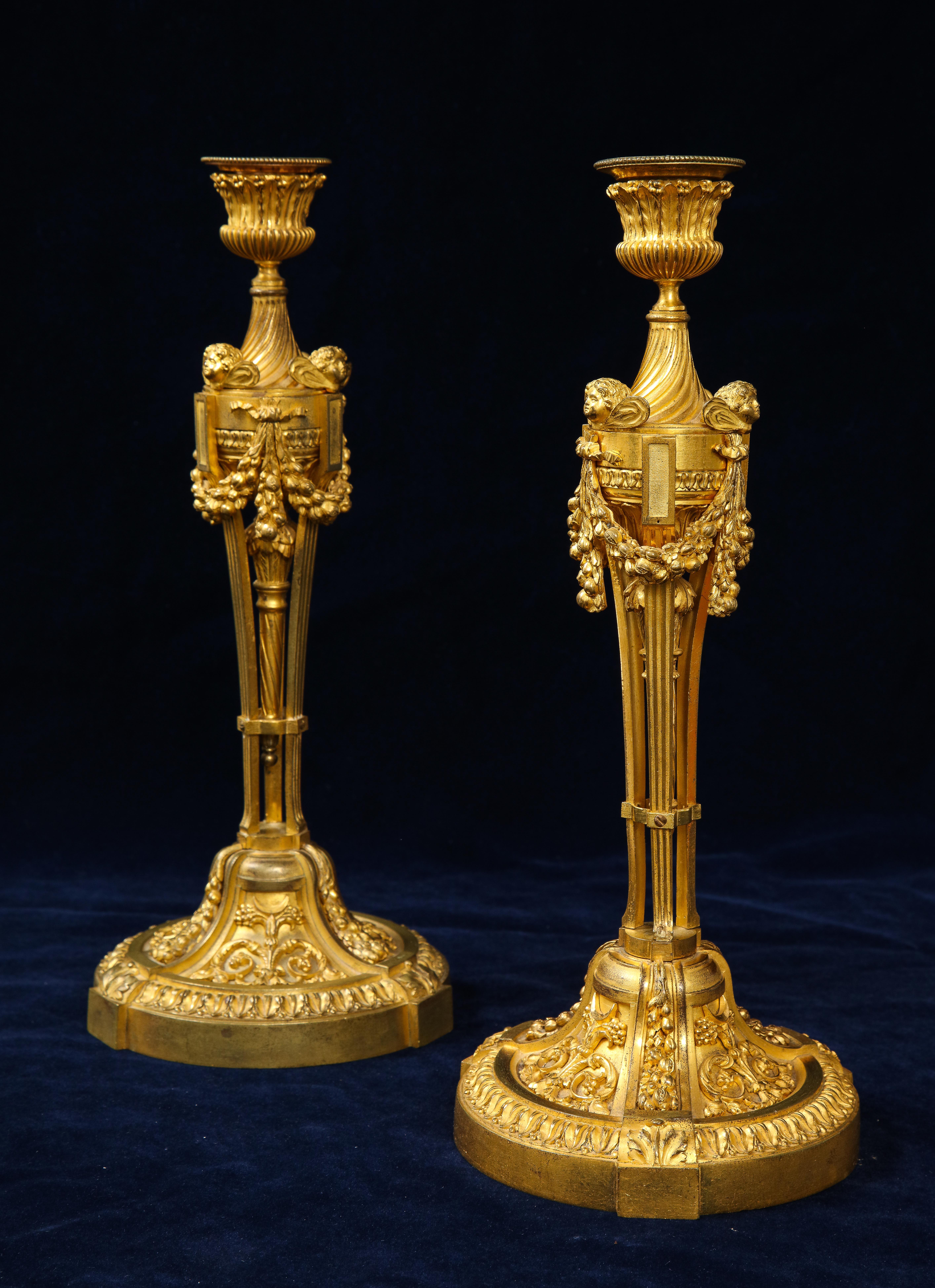 Gilt Pair of French Louid xvi Ormolu Candlesticks with Putti Masks and Garlands For Sale