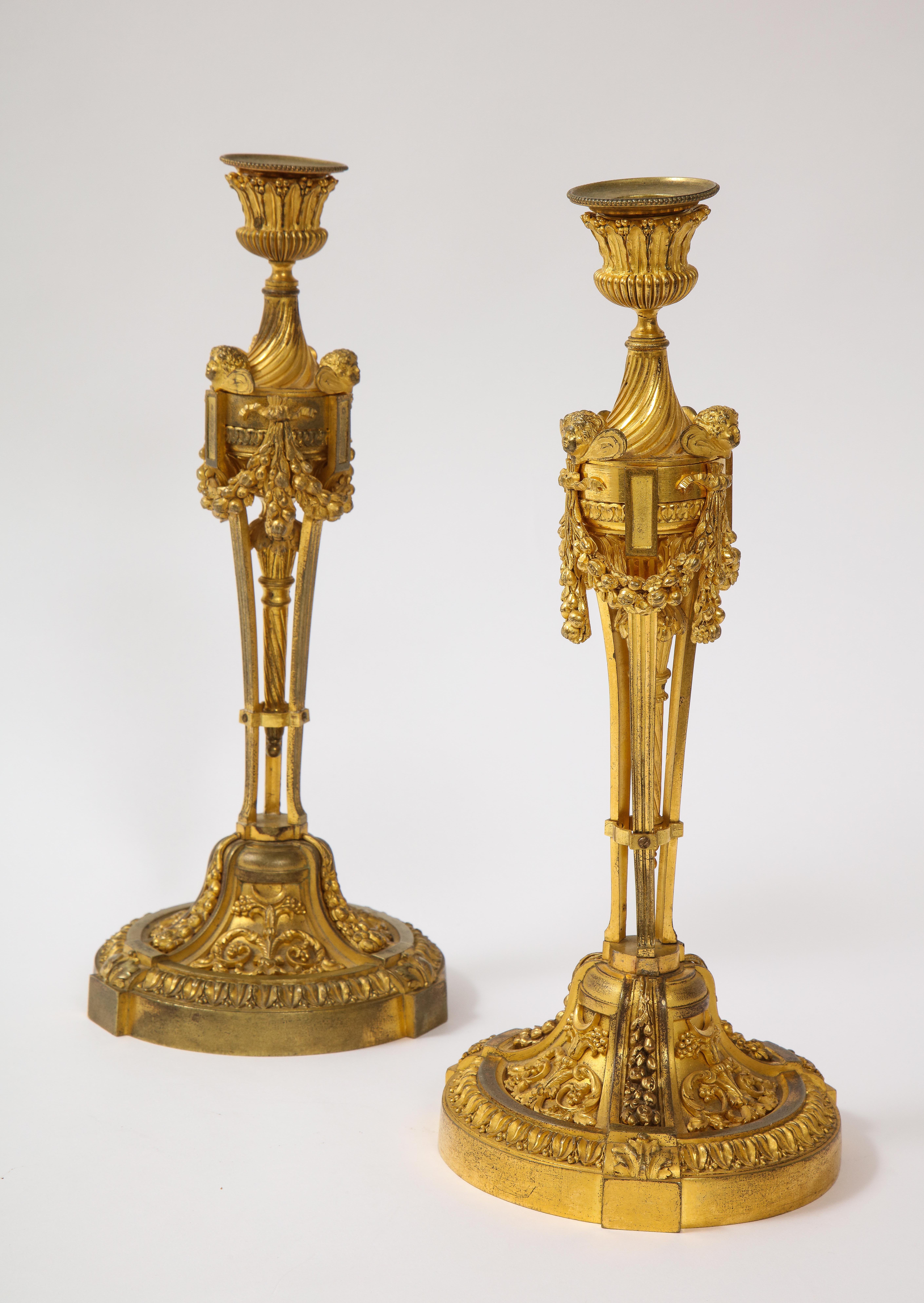 Bronze Pair of French Louid xvi Ormolu Candlesticks with Putti Masks and Garlands For Sale
