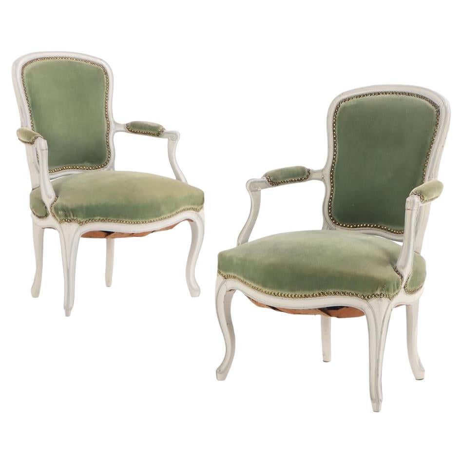 A pair of French Louis XV painted open armchairs, 18th C.
