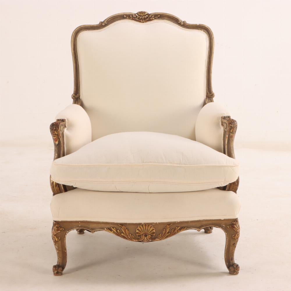This pair of painted and giltwood chairs have deep molded frames with gracefully curved serpentine backs and scrolled arms. The generous seats and arms are upholstered, all supported by cabriole legs ending in scrolled feet.

They have recently been