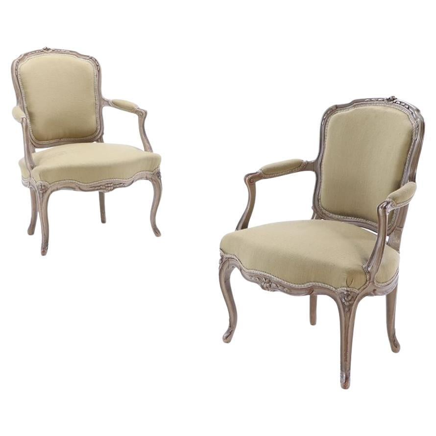 A pair of French Louis XV style painted open armchairs circa 1900. For Sale