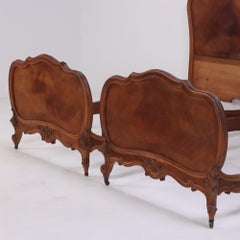 A pair of French Louis XV style walnut twin beds, C. 1900.