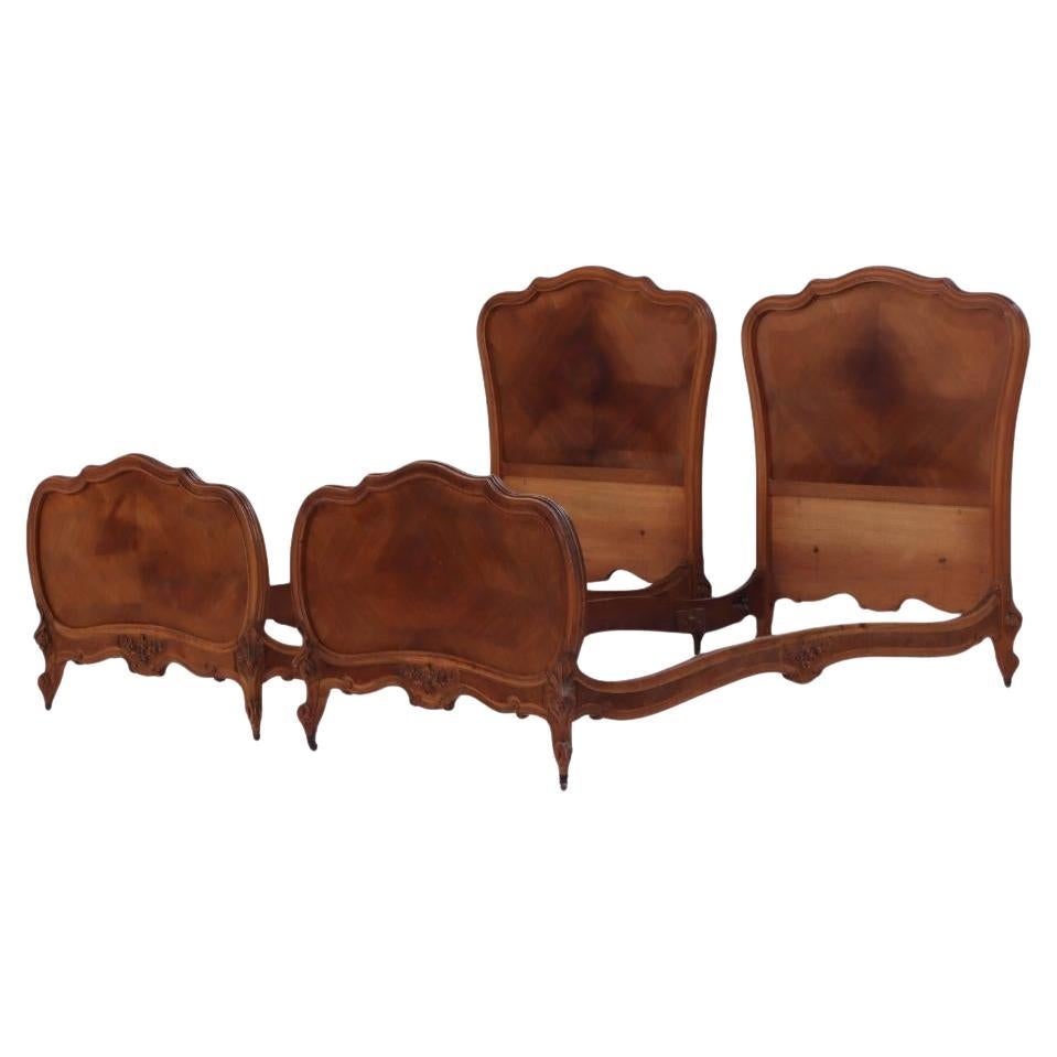 A pair of French Louis XV style walnut twin beds, C. 1900.