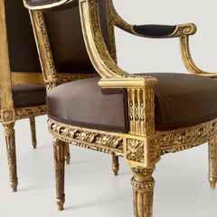 A pair of French Louis XVI Carved Giltwood fauteuils, late 18th century Stamped