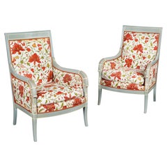 A Pair of French Louis XVI Style Blue Painted Fauteuils with Red Floral Fabric
