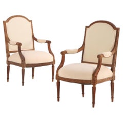 A Pair of French Louis XVI style carved open arm chairs, C 1920.