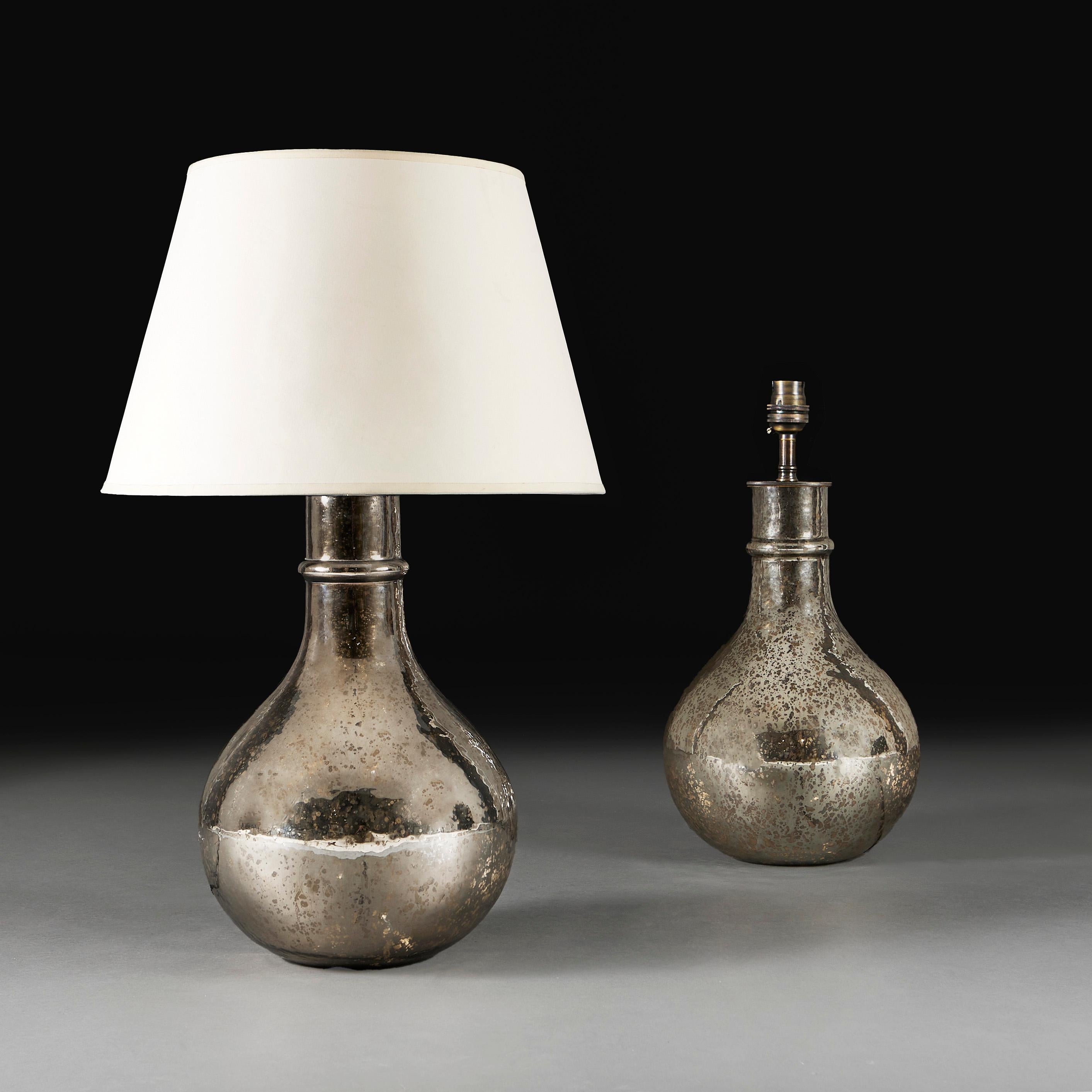 France, modern

A pair of bottle shaped vases of bulbous form, decorated with patinated mercury glass, now as lamps.

Height of vase     44.00cm
Height with lampshades   73.00cm
Diameter of base  26.00cm

Please note: Does not include Lampshades.