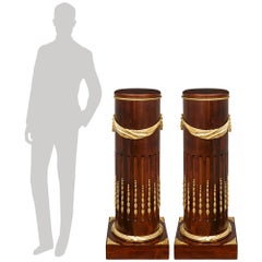 A pair of French mid 19th century Louis XVI st. Mahogany and Ormolu pedestals