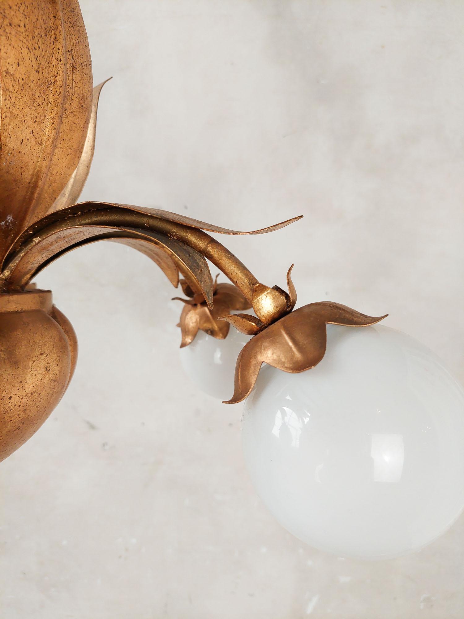 Metal A pair of French, mid-century gold patinated Hollywood Regency lamps with leaves For Sale