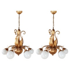 A pair of French, mid-century gold patinated Hollywood Regency lamps with leaves