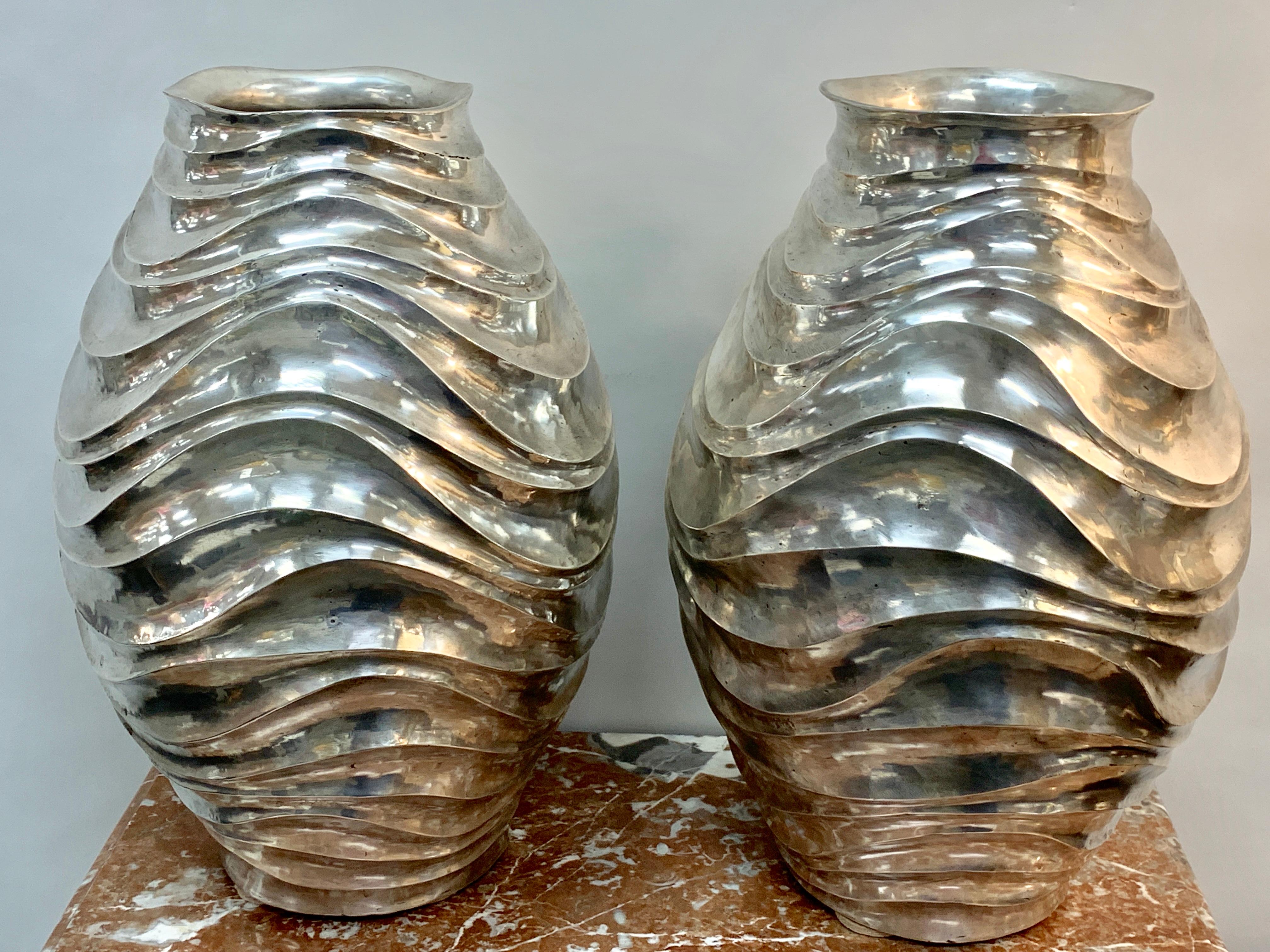 A Pair of French modern silver plated Vases, Each one handmade, chased with continuous undulating lines, each one bearing Artist signature in script 
