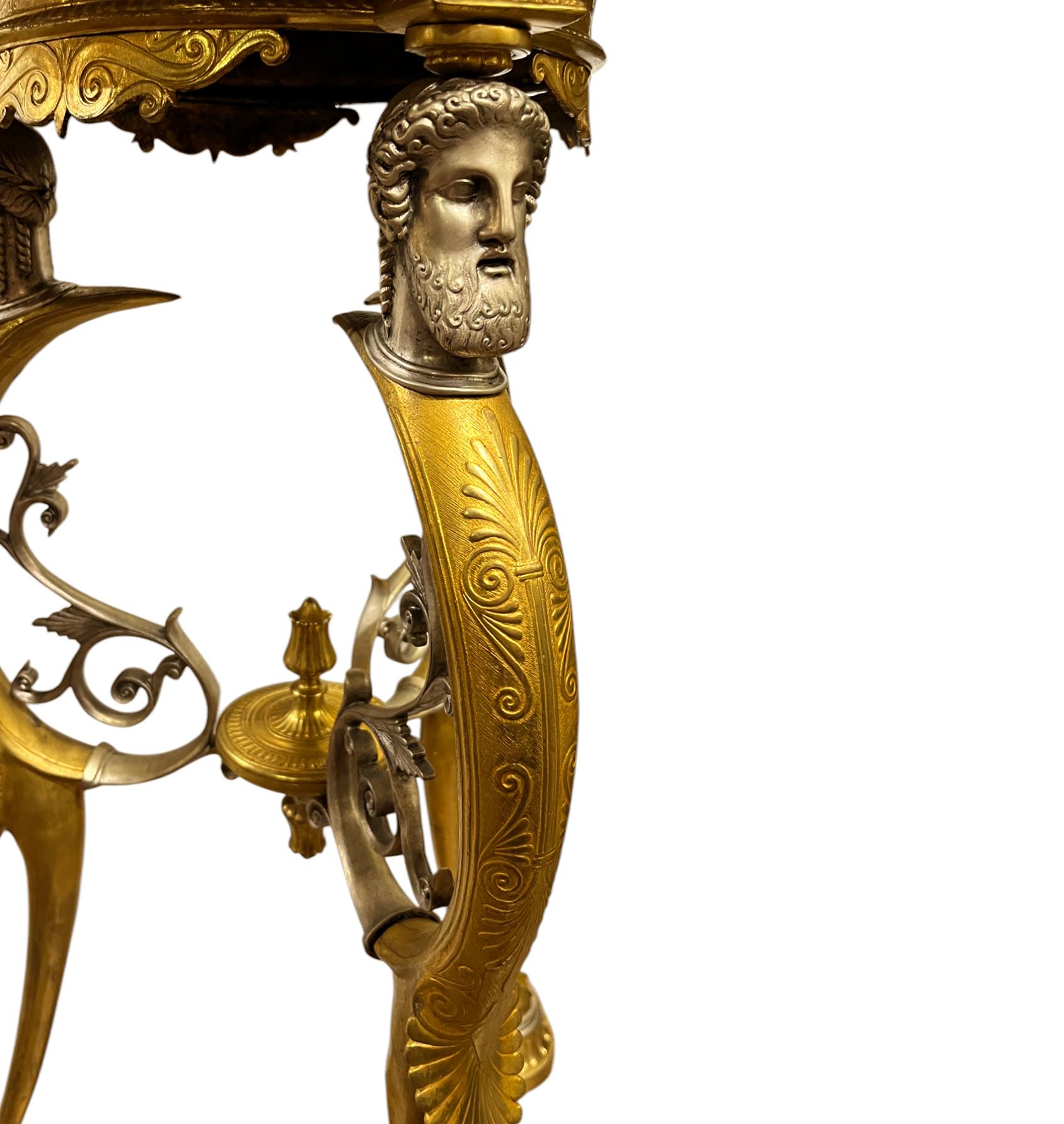 A  Fino par de mesas de mármol dorado y bronce plateado de estilo neoclásico francés
ATRIBUIDOS A FERDINAND BARBEDIENNE Y GEORGES-EMILE-HENRI SERVANT, BRONCES SEGÚN LA ANTIGÜEDAD Y FUNDIDOS A PARTIR DE MODELOS DE EMILE HERBERT, PARÍS.
Principios del