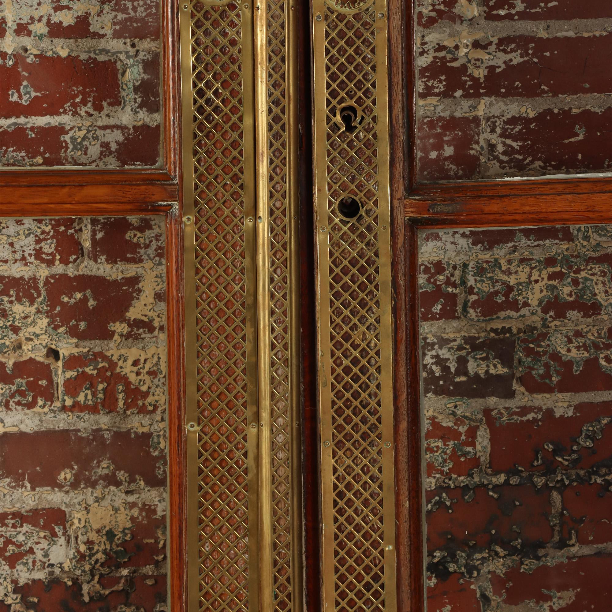 A pair of French oak doors with brass details. C 1900
Total W: 67