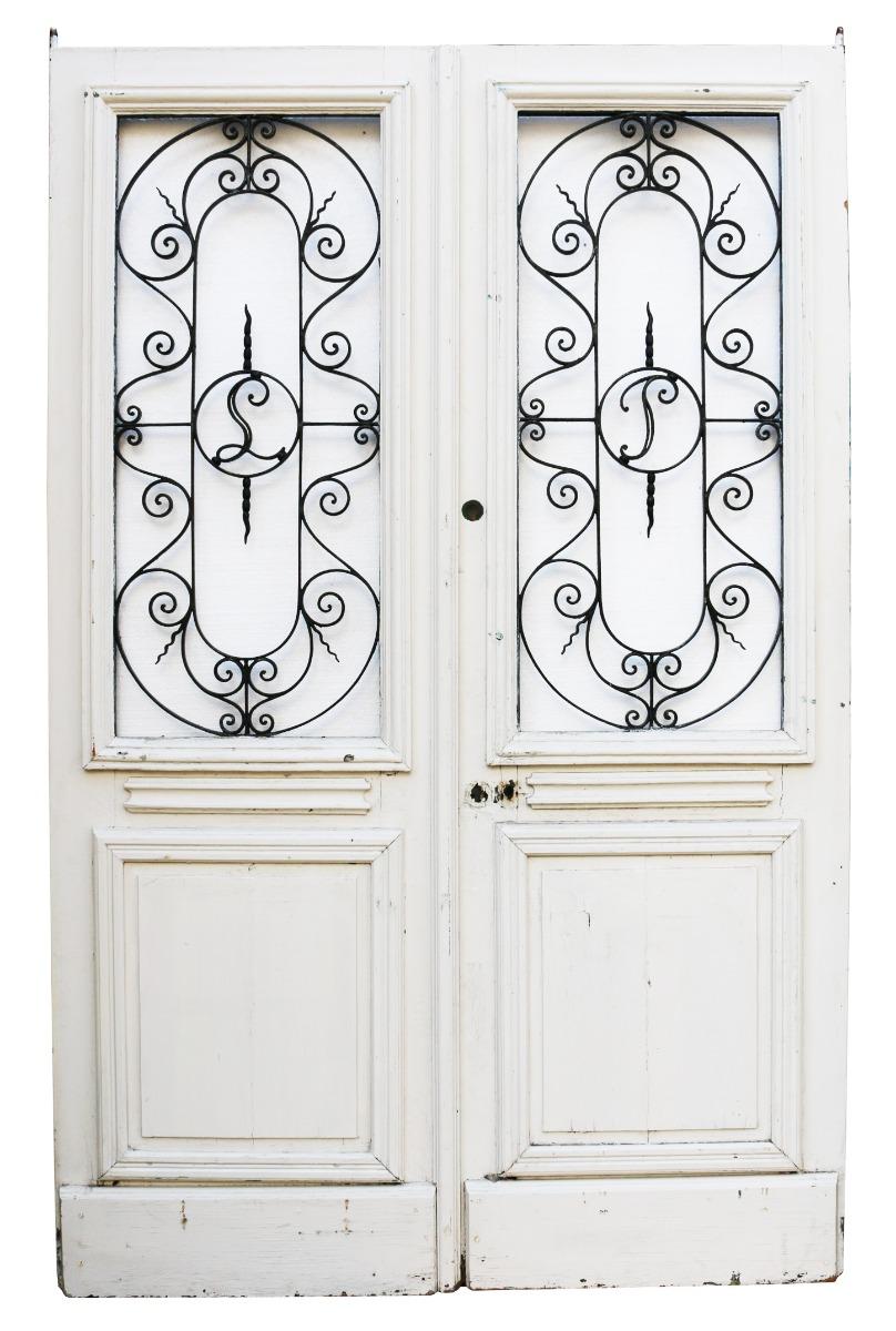 These doors were salvaged in northern France. Made from oak, they currently have a painted finish. The wrought iron monograms can be removed if required.