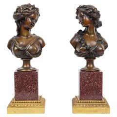 Paar französische figurale Büsten aus Goldbronze und patinierter Bronze auf Porphyrsockeln