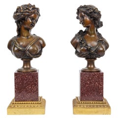 Paire de bustes figuratifs français en bronze doré et patiné sur socle en porphyre