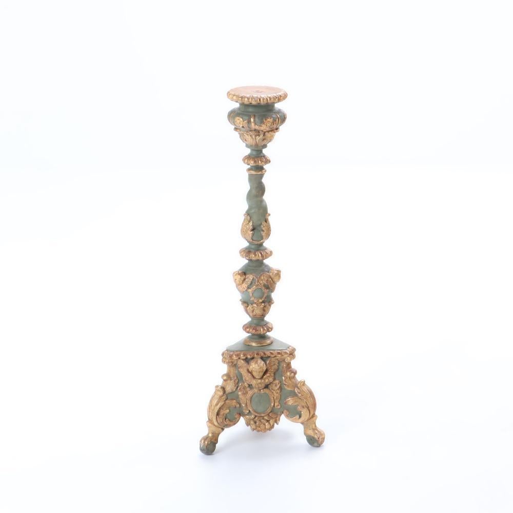 A pair of French painted and giltwood altar candlesticks, C 1820. Each tripartite base having winged cherub carvings and ball and claw feet. Perfect for your sideboard or console table 