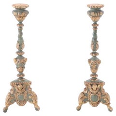 A pair of French painted and giltwood altar candlesticks, C 1820.