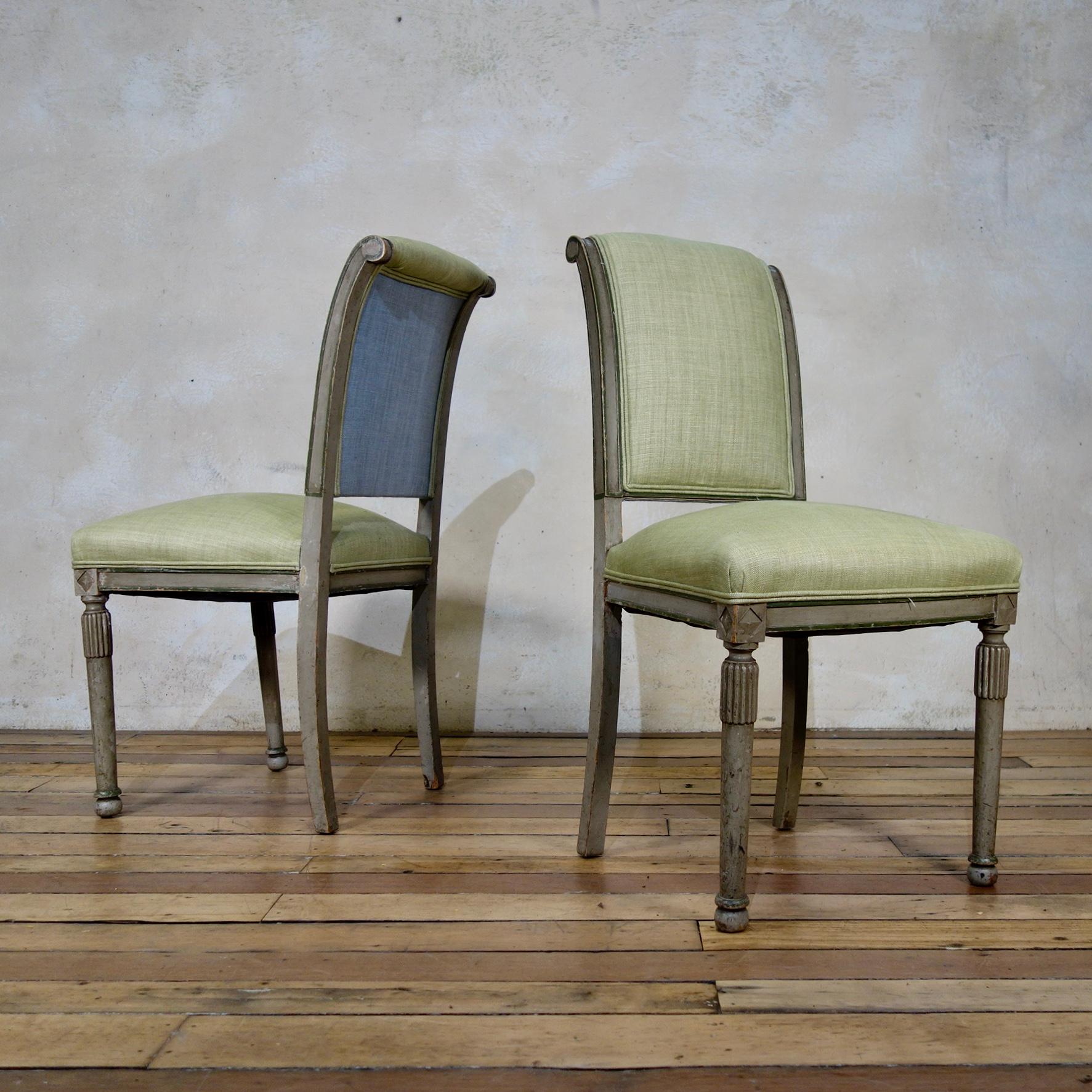 A lovely pair of French 19th century Louis XVI style side chairs. Demonstrating subtly rounded upholstered backs over green linen upholstered seats with green double piped detail. 
Raised on elegantly reeded legs, terminating on rounded feet.