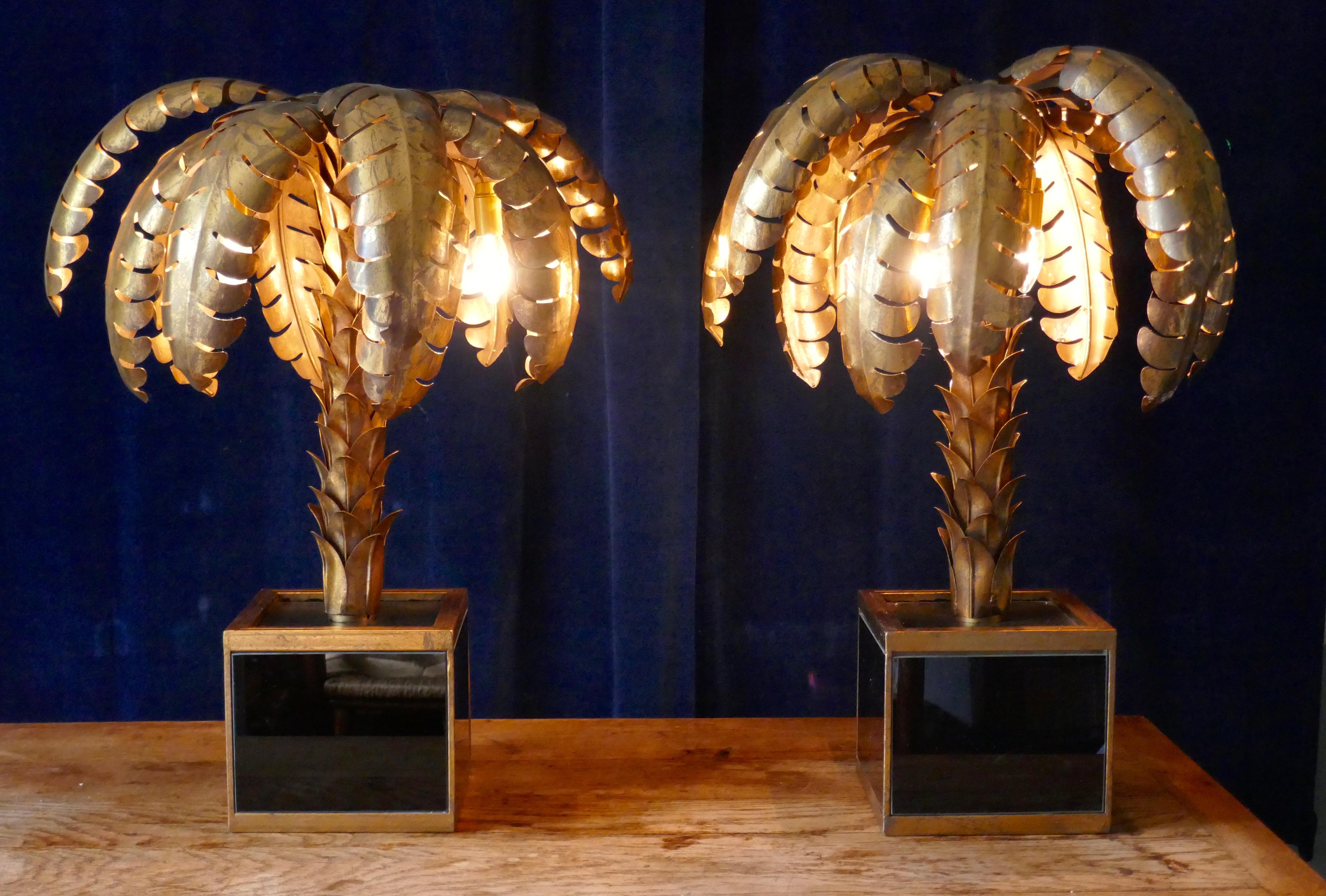 A pair of French palm tree Tole ware table lamps, circa 1970

We have here a pair of table lamps, the old wiring has been removed and replaced with new and we had had English plugs put on both lamps

These toleware lamps have a gilded finish they