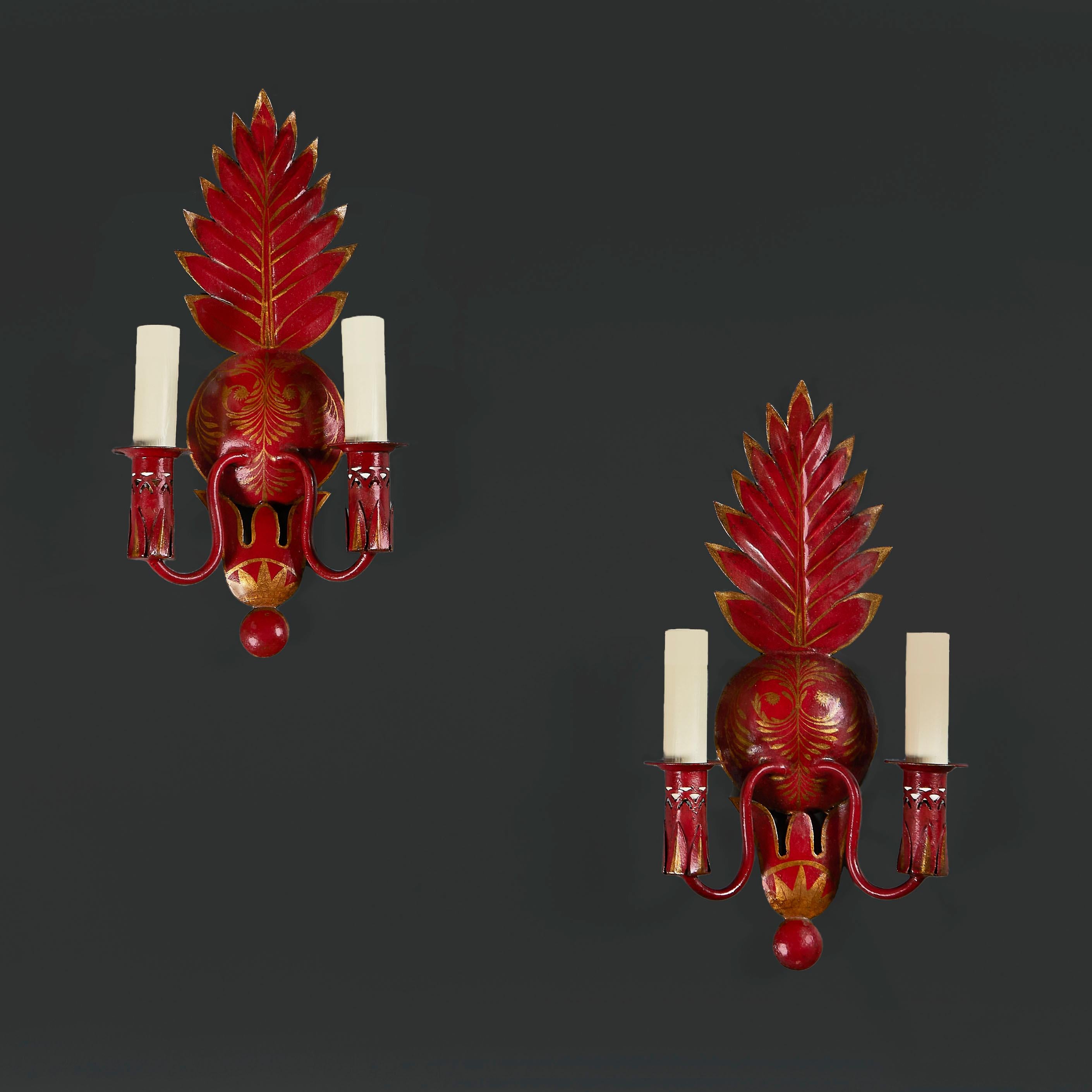 France, circa 1930

A pair of twin branch red tole wall lights in the form of anthemions, decorated with gilded neoclassical designs throughout.

Height 39.00cm
Width 27.00cm
Depth 8.00cm

Currently wired for the UK, with BC bulb fittings, twisted