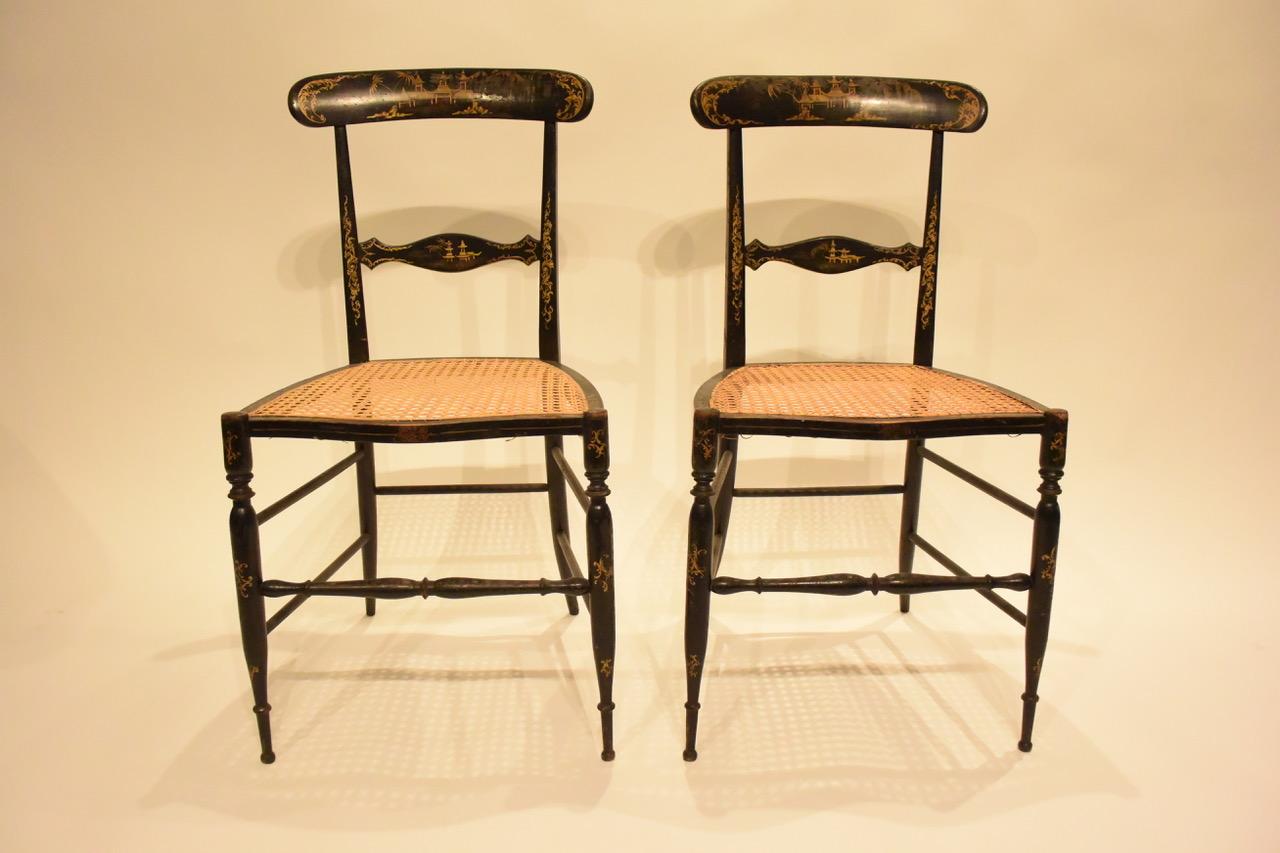 A pair of French Chiavari style chairs with chinoiserie detail on backs and caned seats.
France,
1850s.