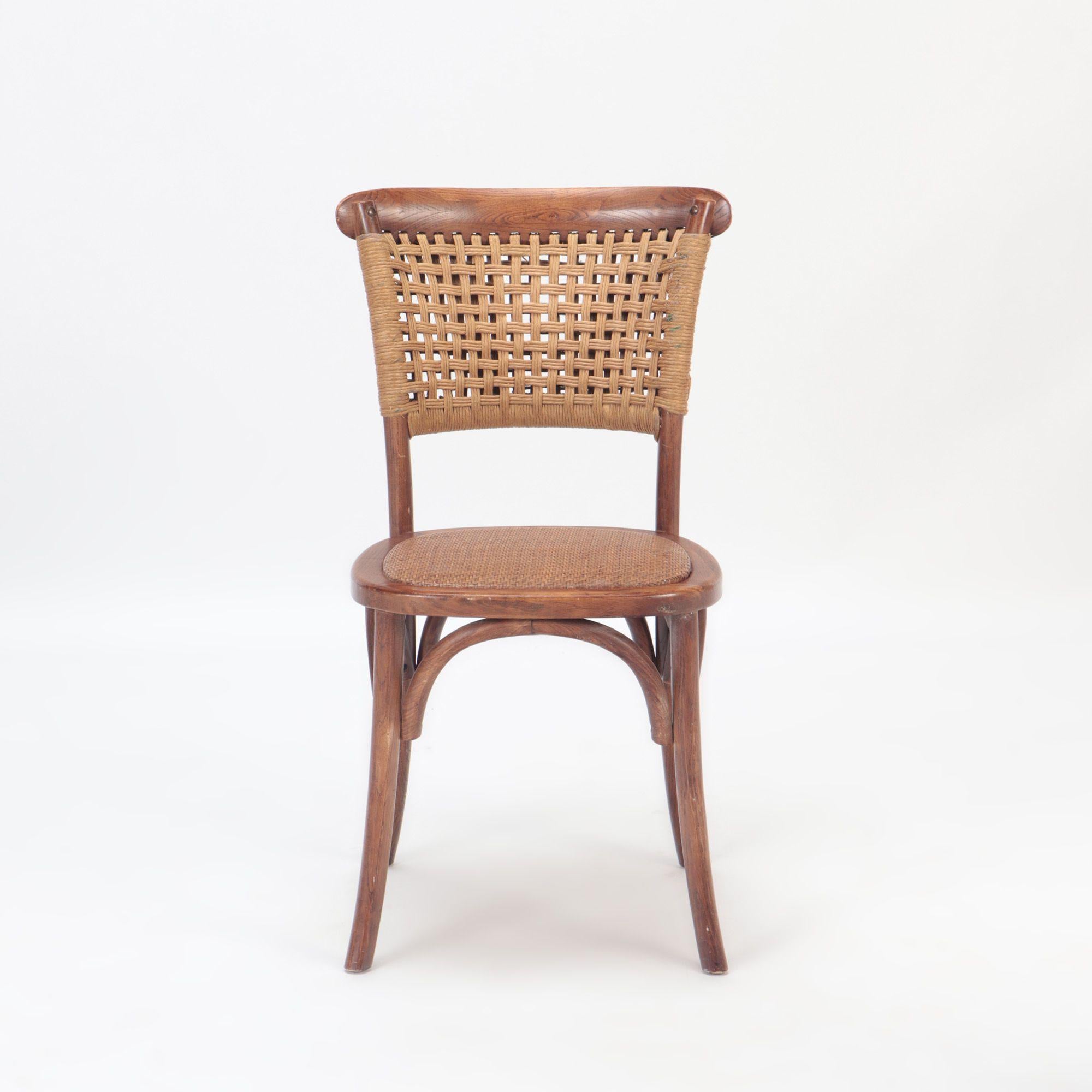 A pair of French Vintage oak side chairs with rattan backs and seats.