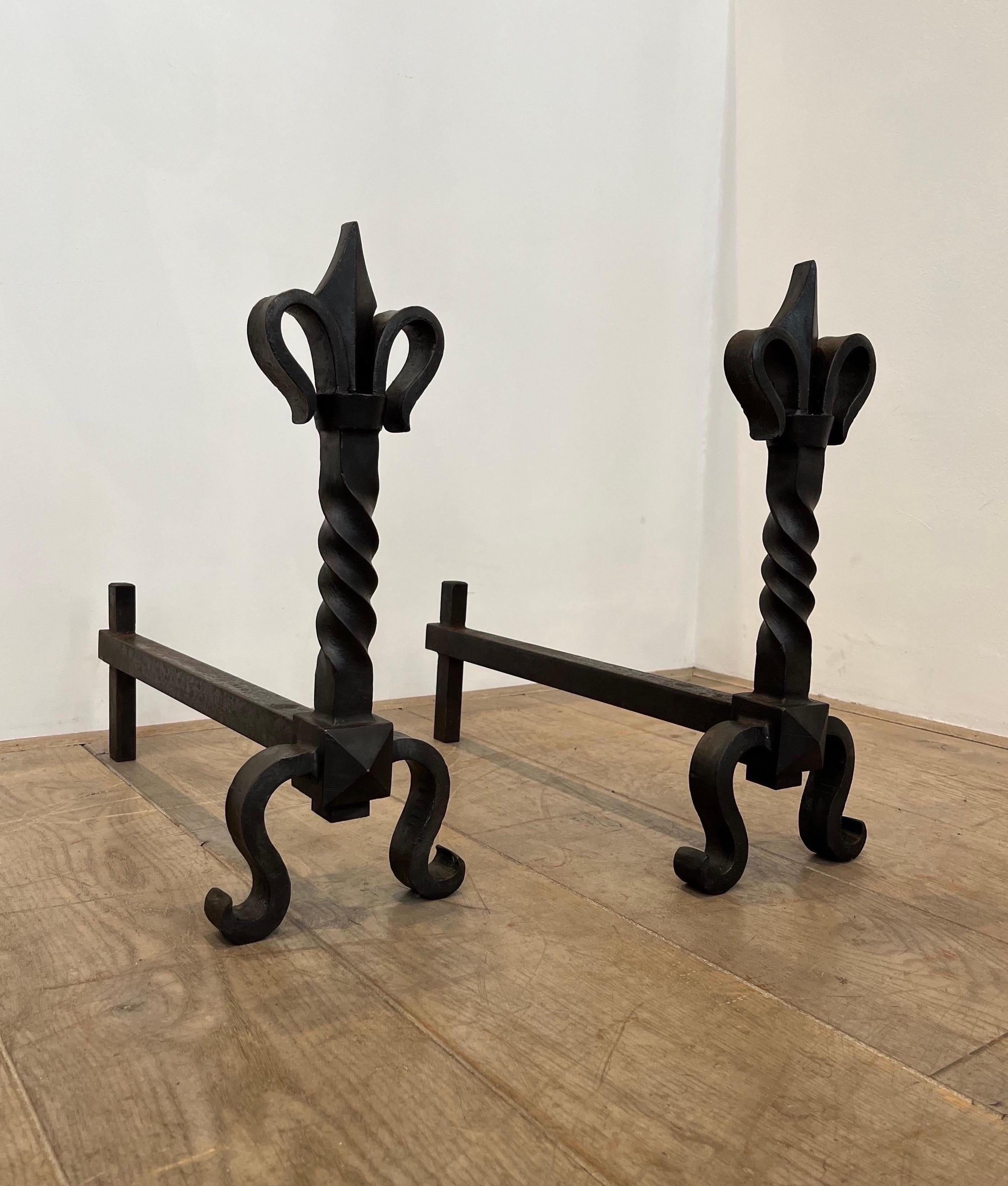 The design is typical of the Decorator Gilbert Poillerat who mastered wrought iron decoration. He was active in the 1940s. They are solid and of great quality.