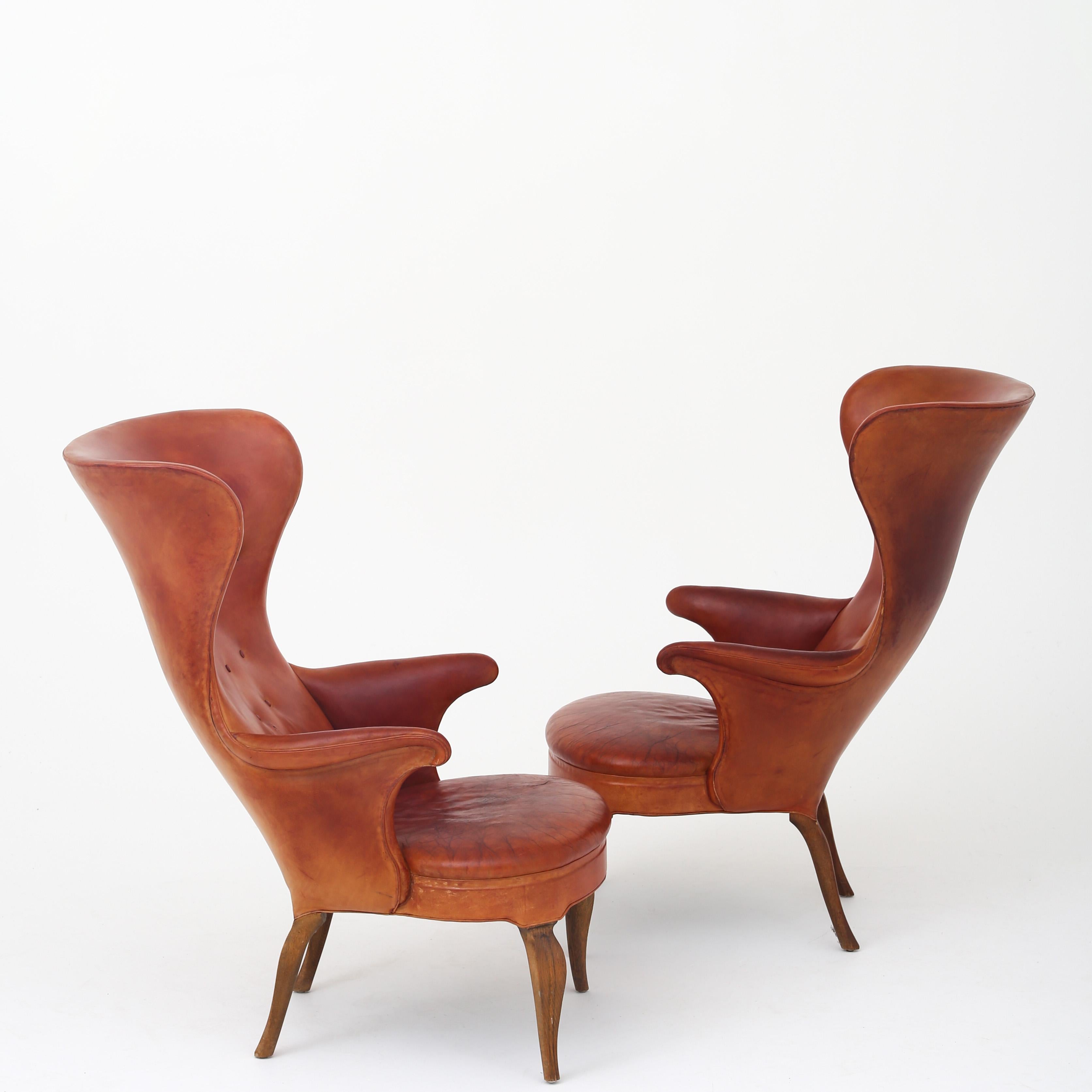 A pair of exceptionally rare 'Wingback' armchairs in original patinated natural leather with solid oak legs. Designed in 1935 and manufactured in the same period. By Frits Henningsen.