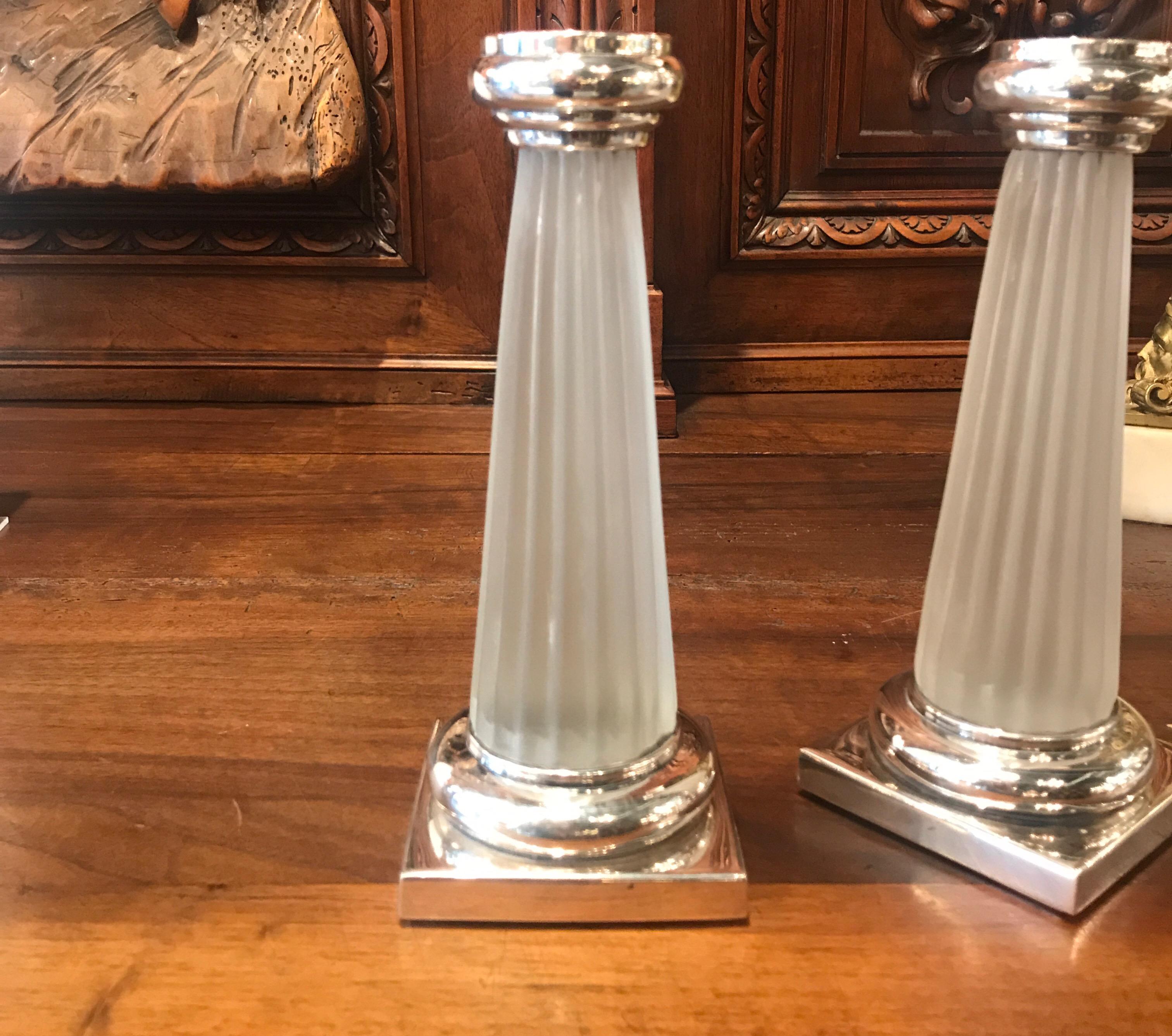 Chic pair of ribbed frosted glass and sterling silver mounted Deco style candlesticks. The pair with silver tops and bases with the center column of frosted glass.