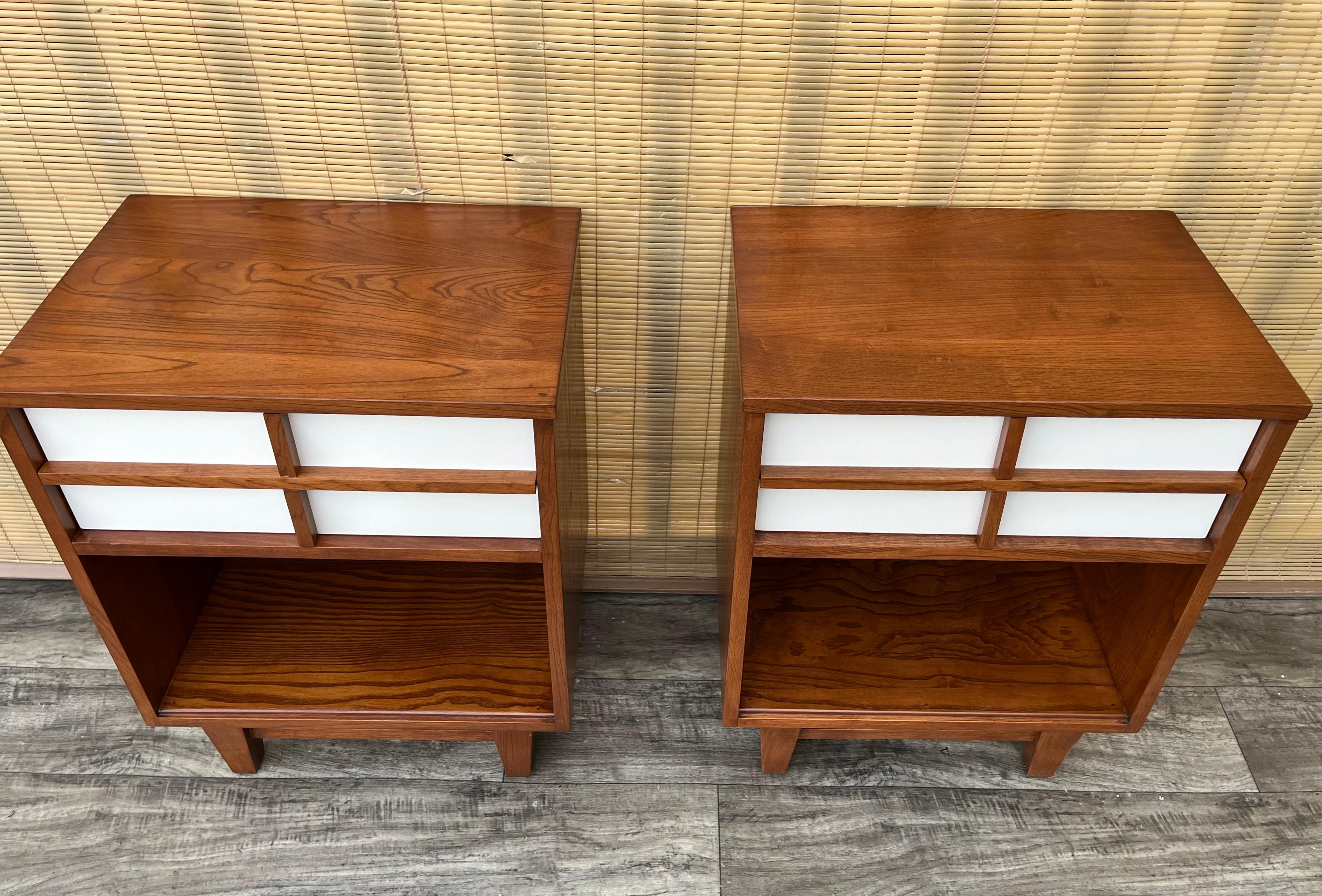 A Pair of Fully Refinished Mid Century Modern Nightstands by Royal Palm Furniture. Circa 1960s.
Feature a quintessential Mid-Century Modern Design with contrasting colors, dovetail joint drawers, and geometric drawer pulls. 
In excellent fully
