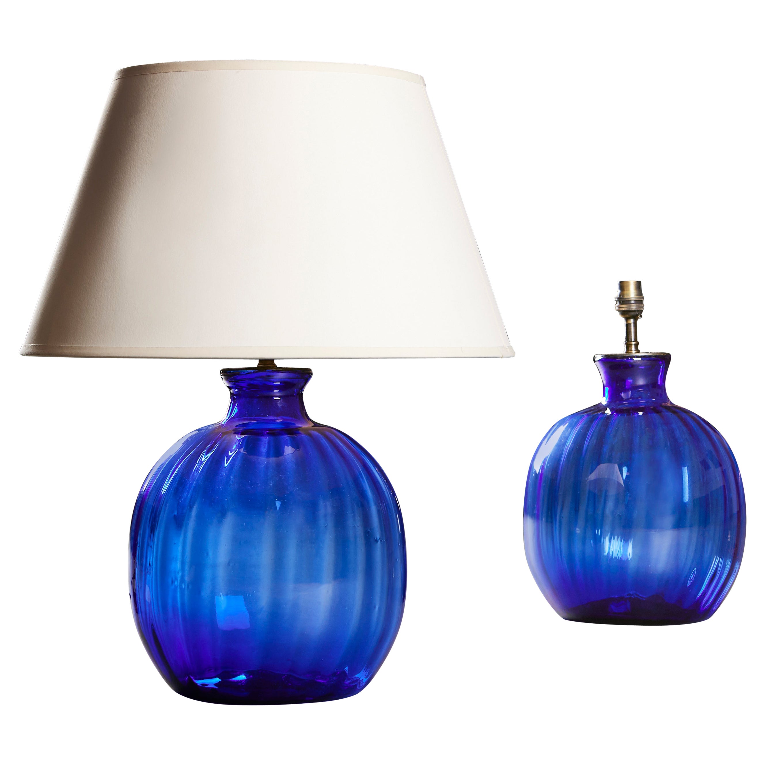 A Pair Of Gadrooned Blue Glass Lamps