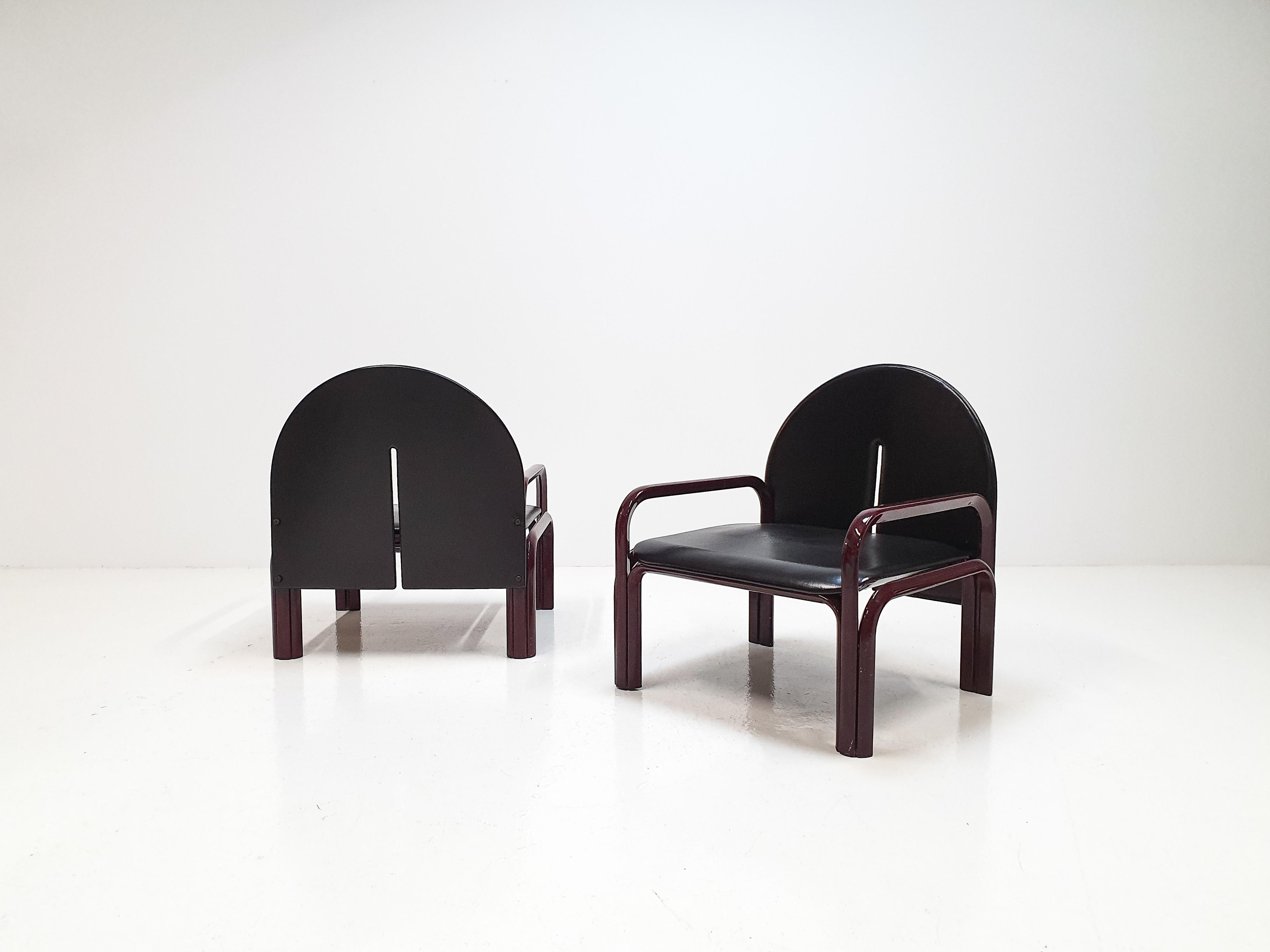 A pair of hard to source tubular steel Model '54 L' armchairs by Gae Aulenti.

Designed in 1976 and produced by Knoll International with Bordeaux red frames and black seat and backrest.

Dimensions:
Height 77 cm / 30.15 inches
Depth 69.5 cm / 27.36