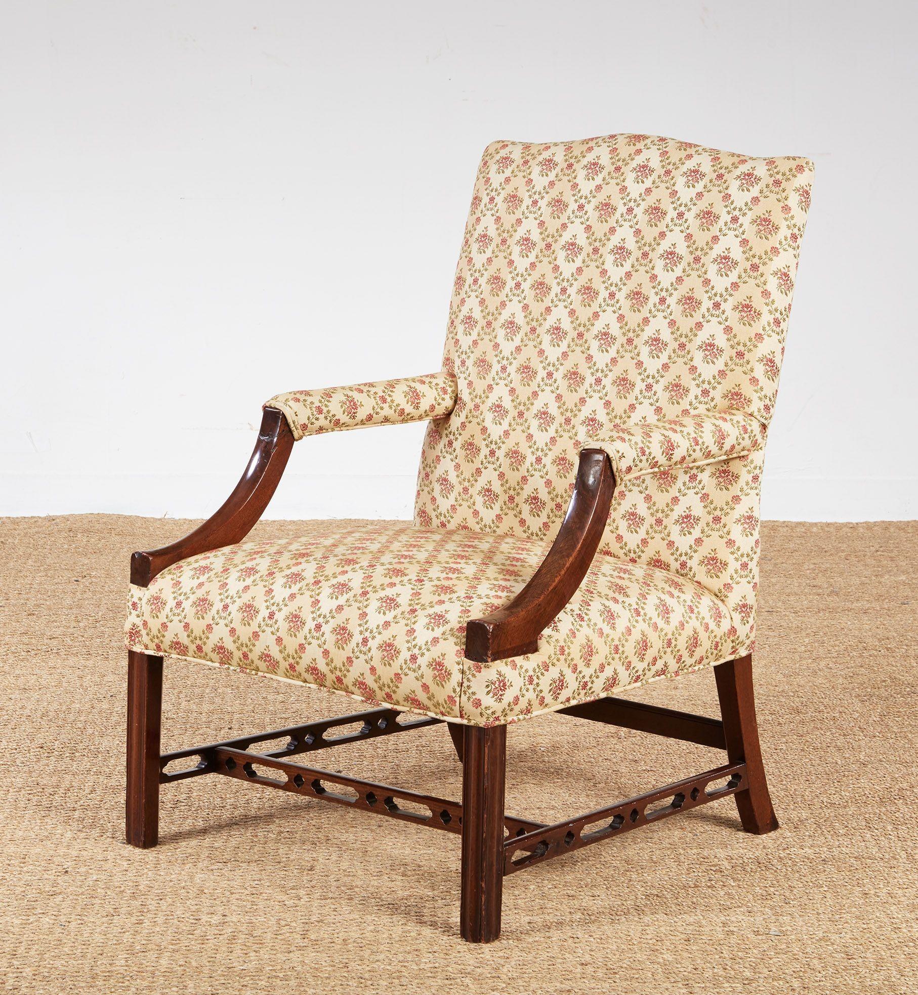 A pair of mahogany Gainsborough armchairs, one chair late 18th century, the other a faithful 20th century copy.   Substantial and comfortable, with shaped upholstered backs, padded arms terminating in down-swept curved supports and upholstered seats